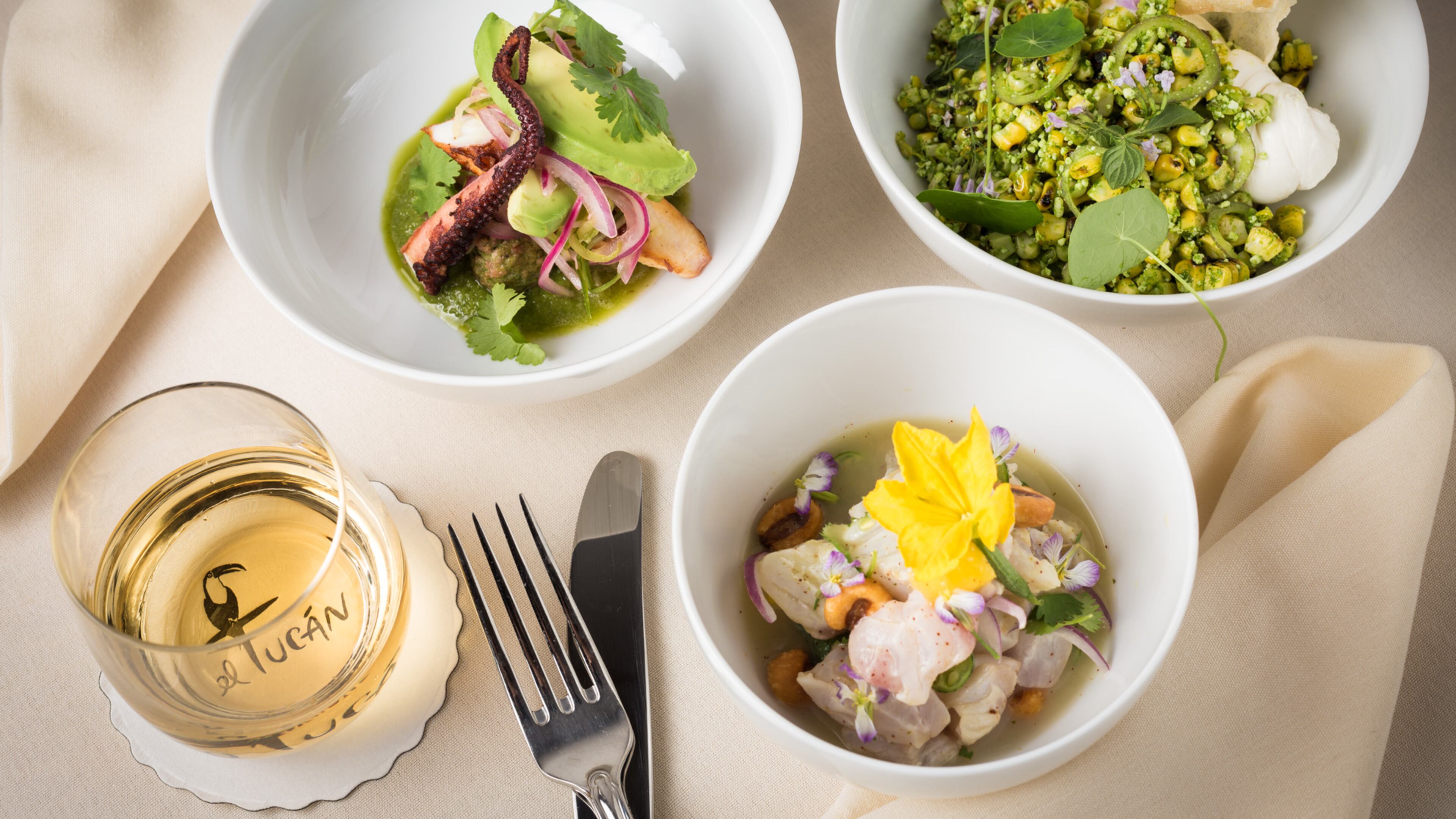 In an undated handout photo, Leche de Tigre Ceviche, Mexican street corn and Pulpo, three dishes served at El Tucan in Miami. The dimly-lit supper club is a proud throwback to an earlier era, where variety shows and dancing share the spotlight with an $85 prix fixe menu.