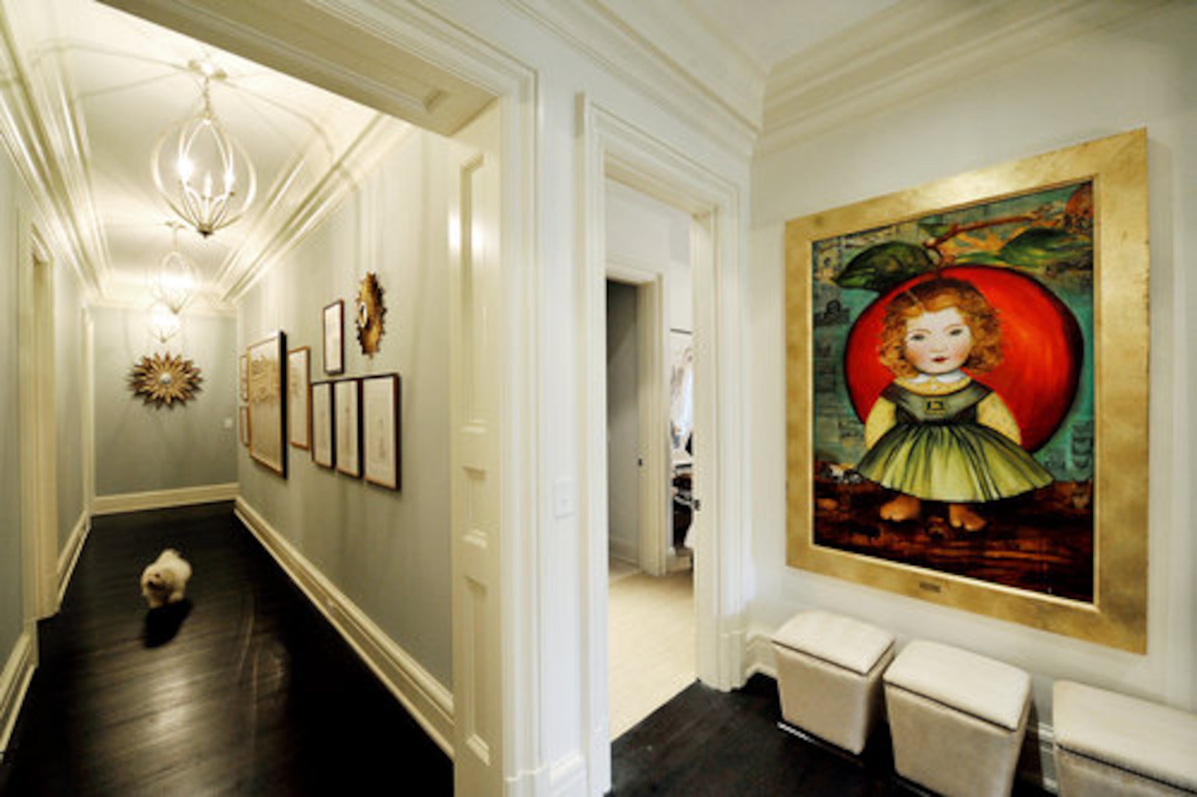 This painting in the upstairs hallway is by Denise Falk, a painting professor at the Savannah College of Art and Design. The farmland references in "Apple Betty" resonate with the couple -- Stan is from Indiana. Melanie was born in Wales. Scurrying down the hallway is Daisy May, originally from Michigan.