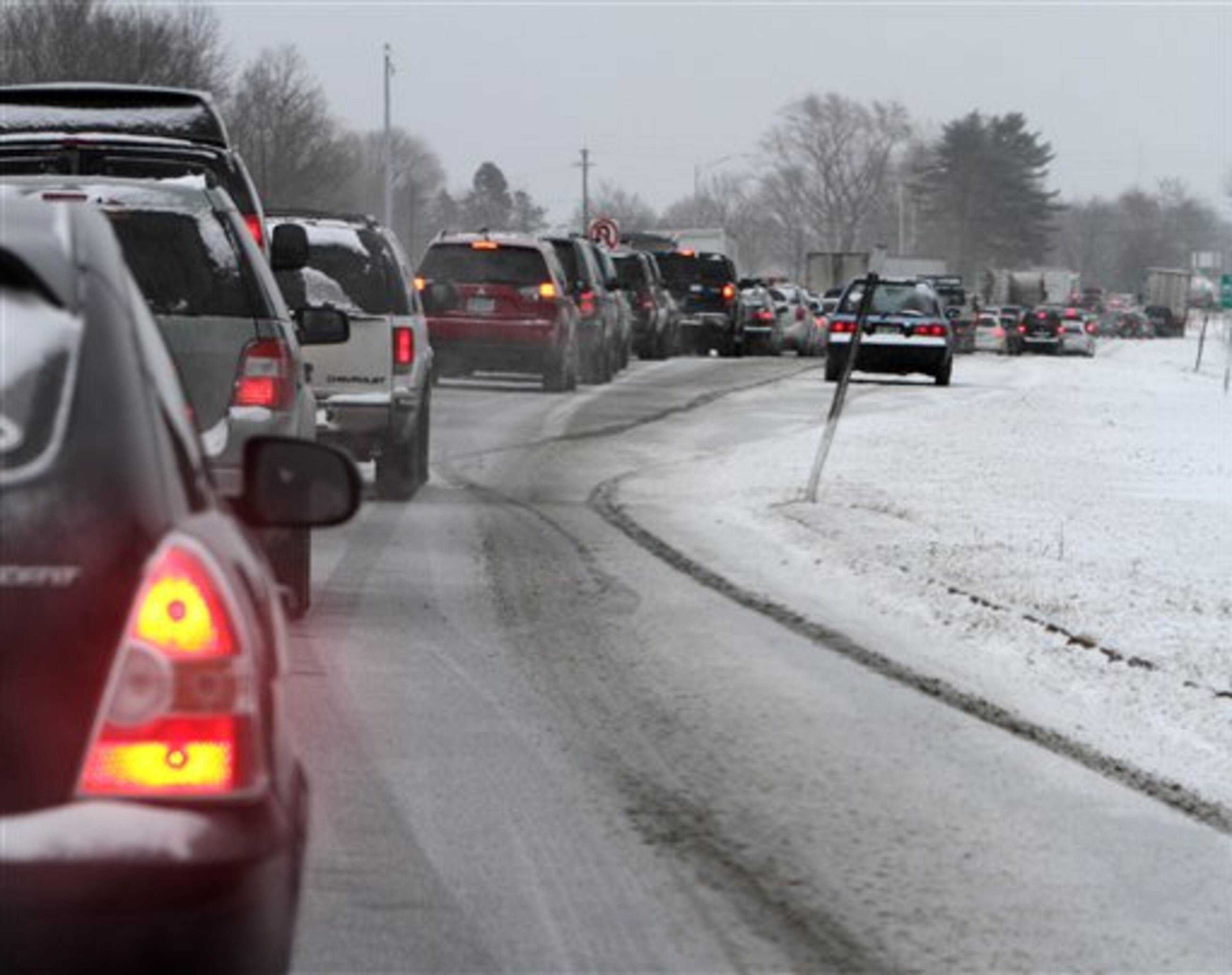 Cars are stuck in traffic as a winter storm arrives , Friday, Feb. 8, 2013 in Newington, N.H. Snow began to fall around the Northeast on Friday at the start of what's predicted to be a massive, possibly historic blizzard, and residents scurried to stock up on food and supplies ahead of the storm. (AP Photo/Jim Cole)