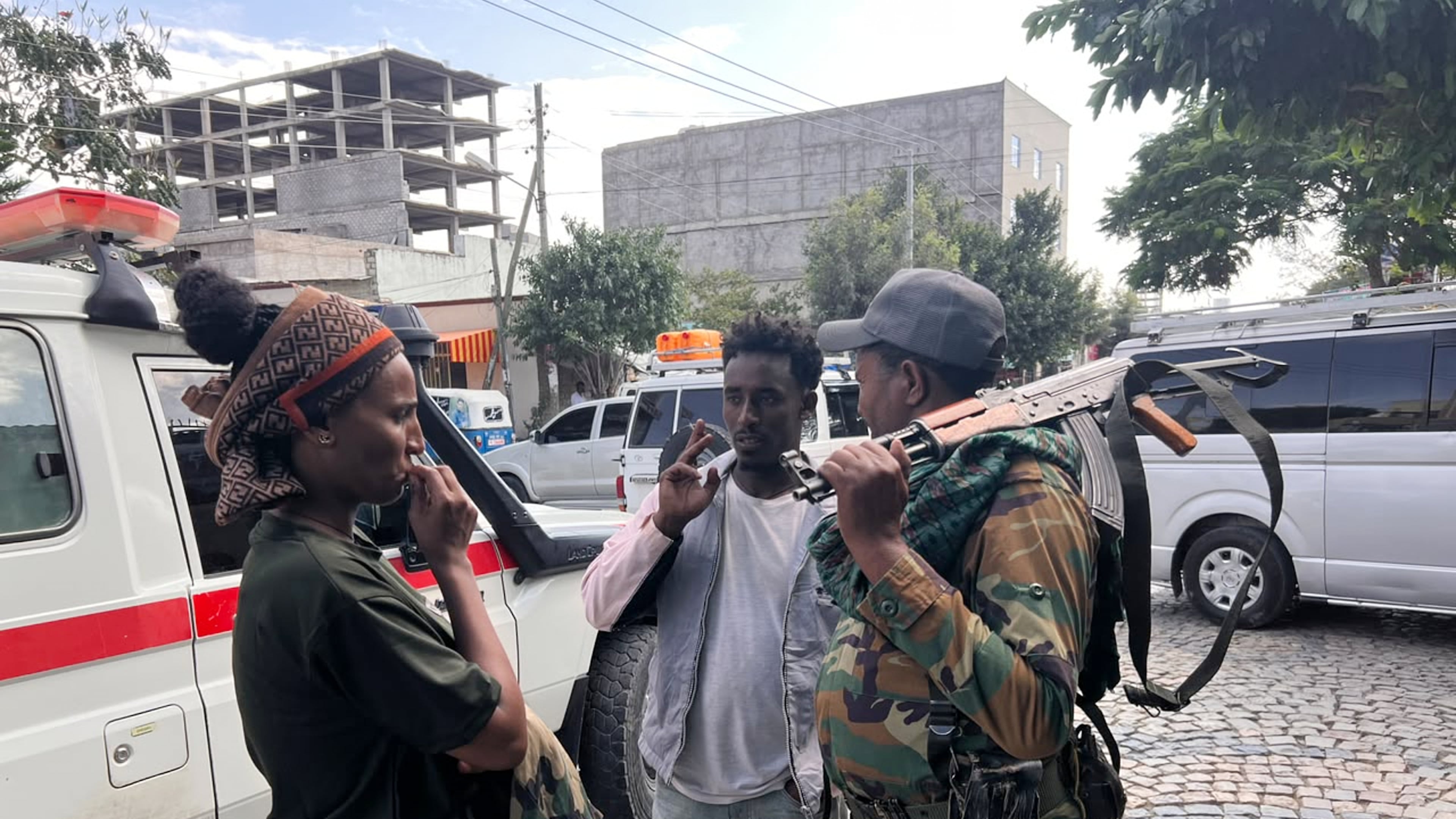 Tigray Peace Force fighters stand beside an ambulance after entering Mekelle, in Ethiopia’s Tigray region, Sunday, Oct. 4, 2026. (AP Photo/Filmon Equar Hailu)