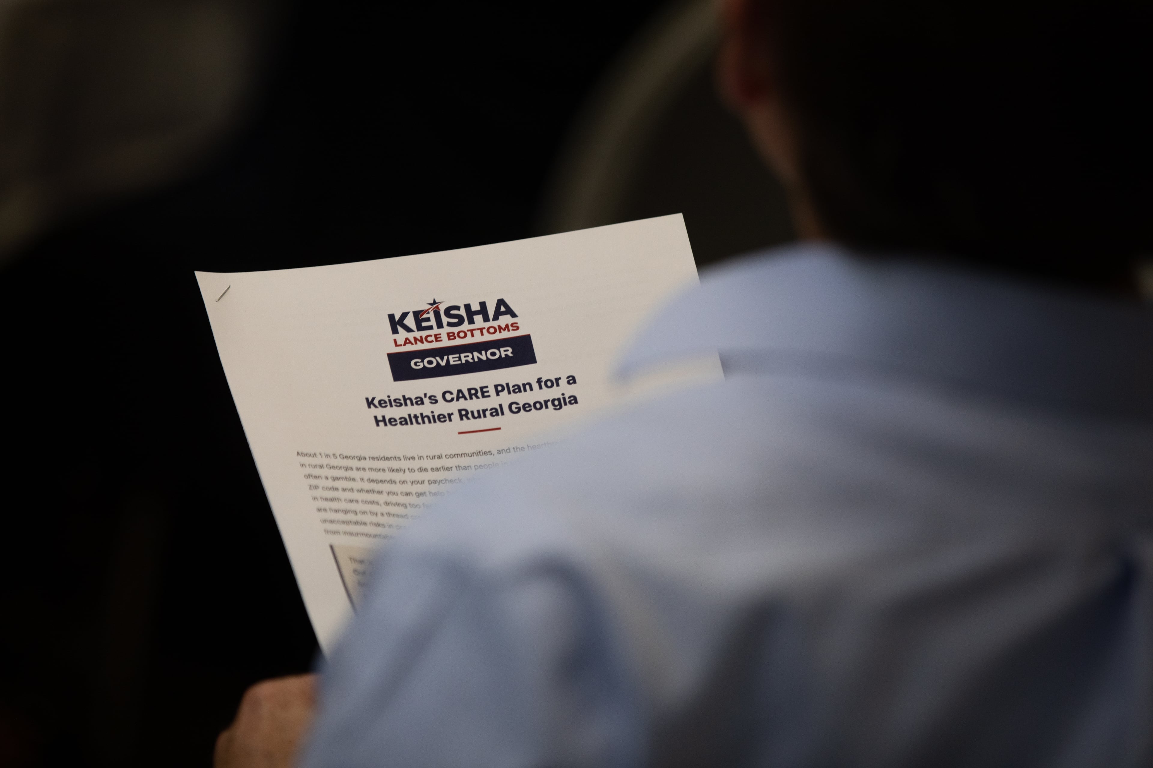 A supporter of Democratic candidate for governor Keisha Lance Bottoms holds a policy packet of her healthcare agenda at a roundtable discussion at Coastal Pines Technical College in Jesup on July 29, 2026. (Riley Bunch/AJC)