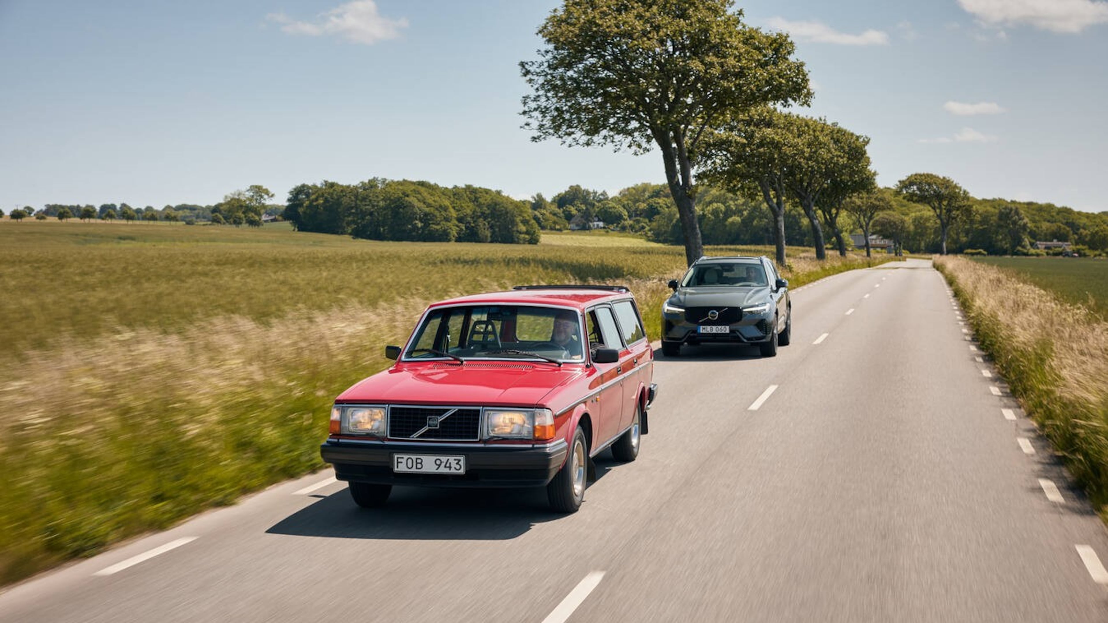 A Volvo 240 in red, followed by a Volvo XC60 Plug-in Hybrid. The 240 is probably the model Americans know best. It was produced from 1974 to 1993. (Brian Moody)
