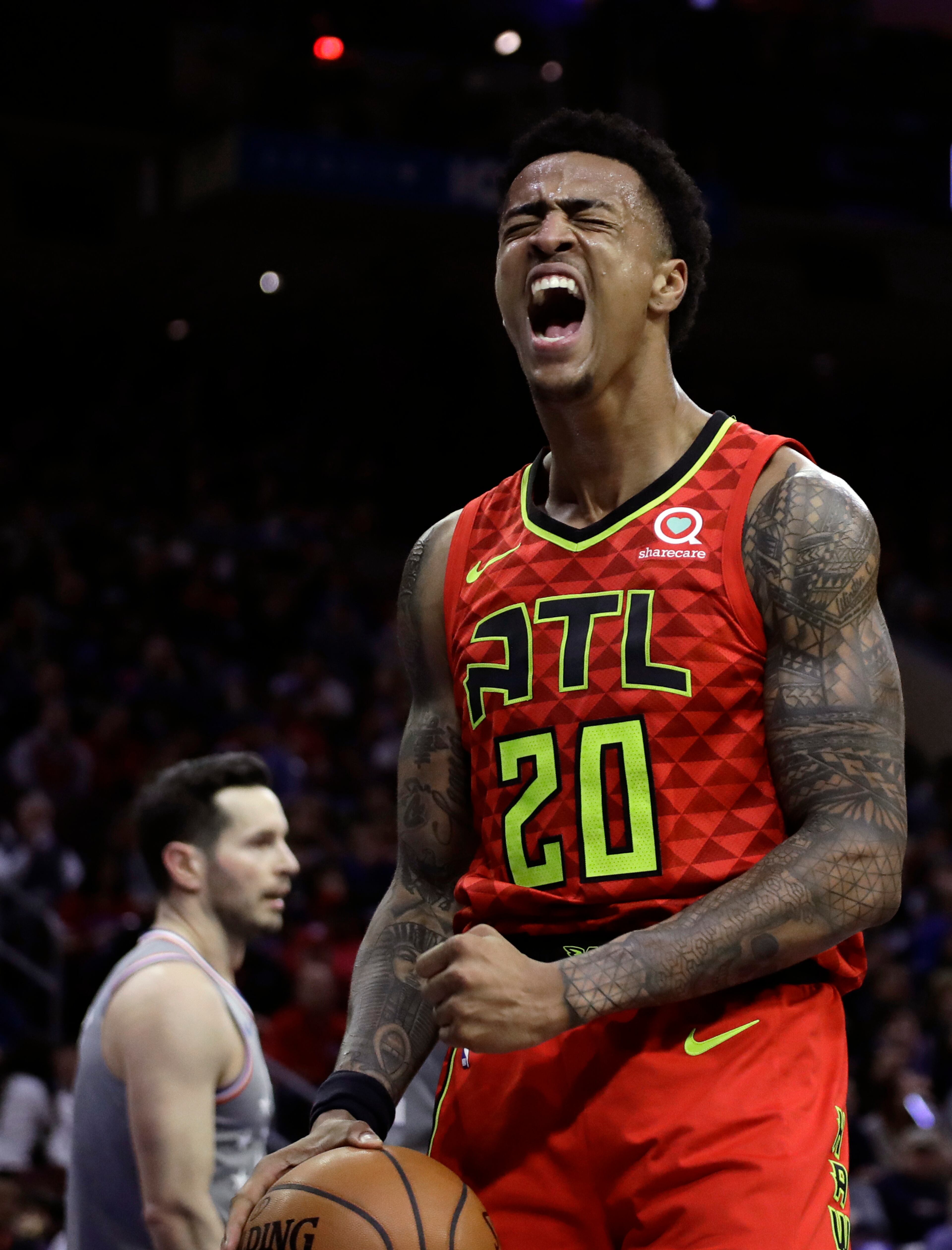 Atlanta Hawks' John Collins reacts after scoring during the first half of an NBA basketball game against the Philadelphia 76ers, Friday, Jan. 11, 2019, in Philadelphia. (AP Photo/Matt Slocum)