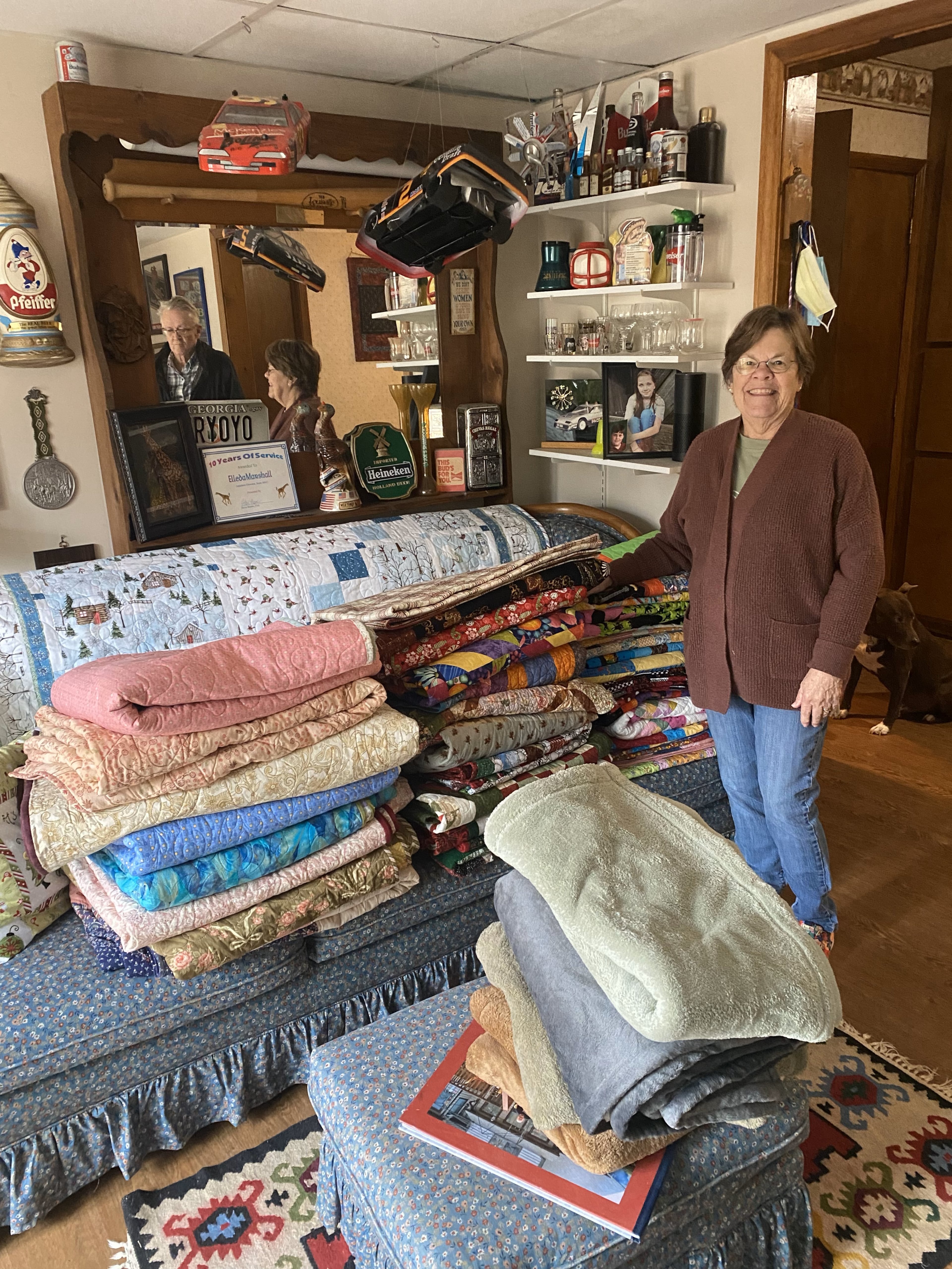 Elleda Rule, a member of the Nesty sewing circle, shows off some of the quilts created by her group. Photo: Jenni Girtman