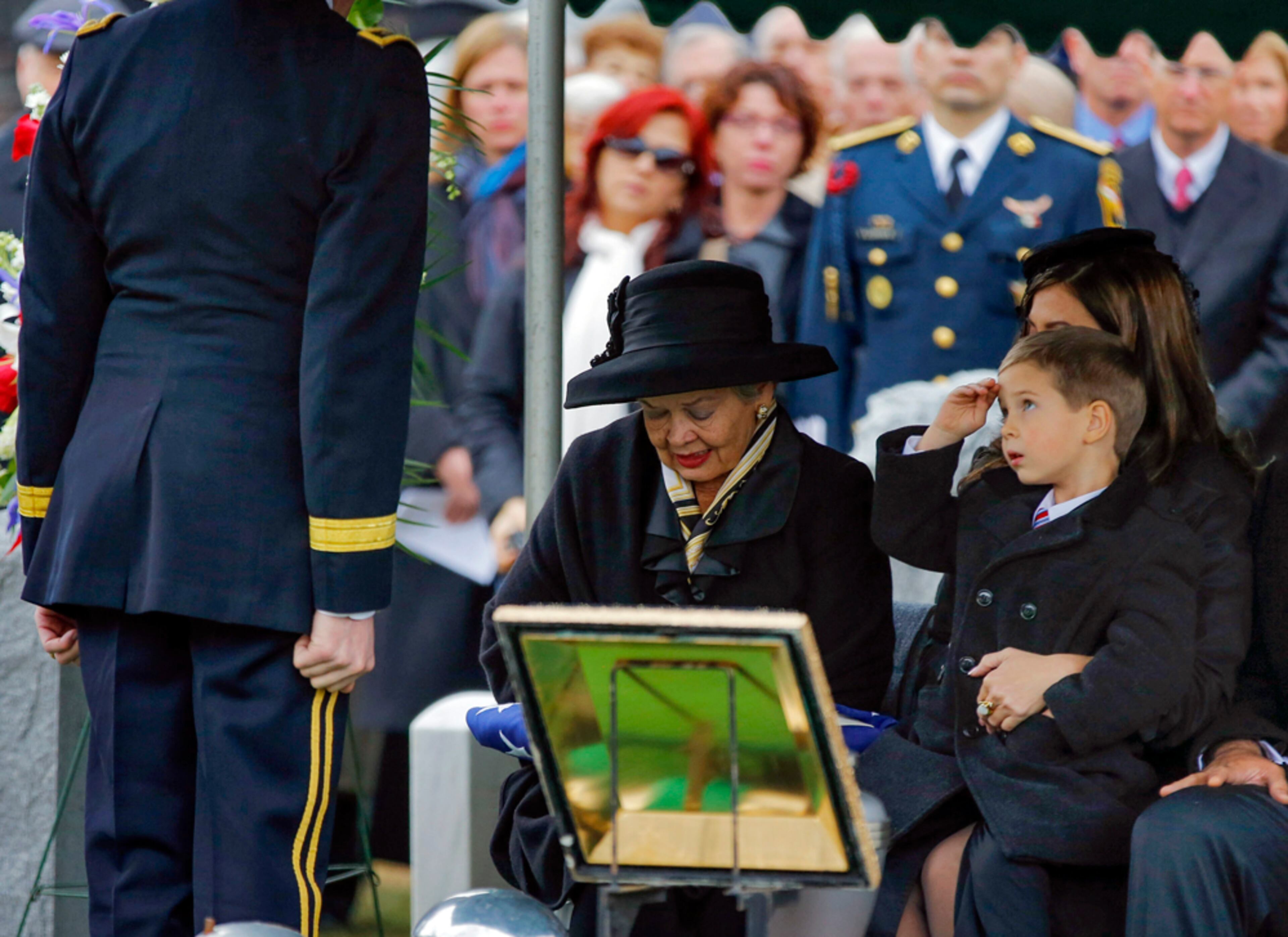 SALUTE FOR A GRANDFATHER--Max Karmazyn, right, sitting next to his grandmother Brenda Schwarzkopf, left, salutes during the burial of his late grandfather, Gen. Norman Schwarzkopf, at the United States Military Academy on Thursday, Feb. 28, 2013, in West Point, N.Y. Schwarzkopf was 78 when he died of complications from pneumonia on Dec. 27 in Tampa. (AP Photo/Philip Kamrass)