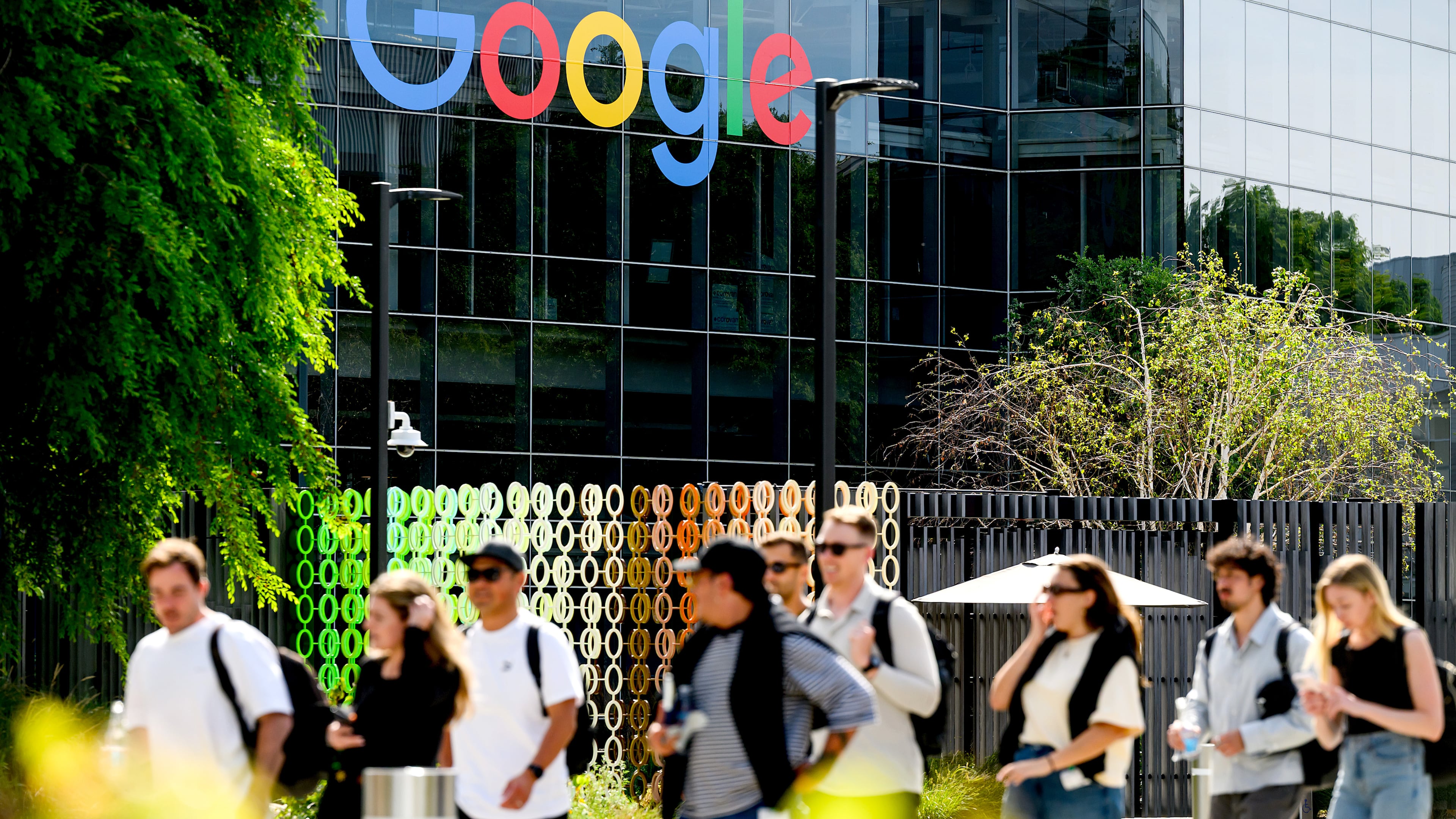 People walk through Google headquarters in Mountain View, Calif., on Thursday, March 26, 2026. (AP Photo/Noah Berger)