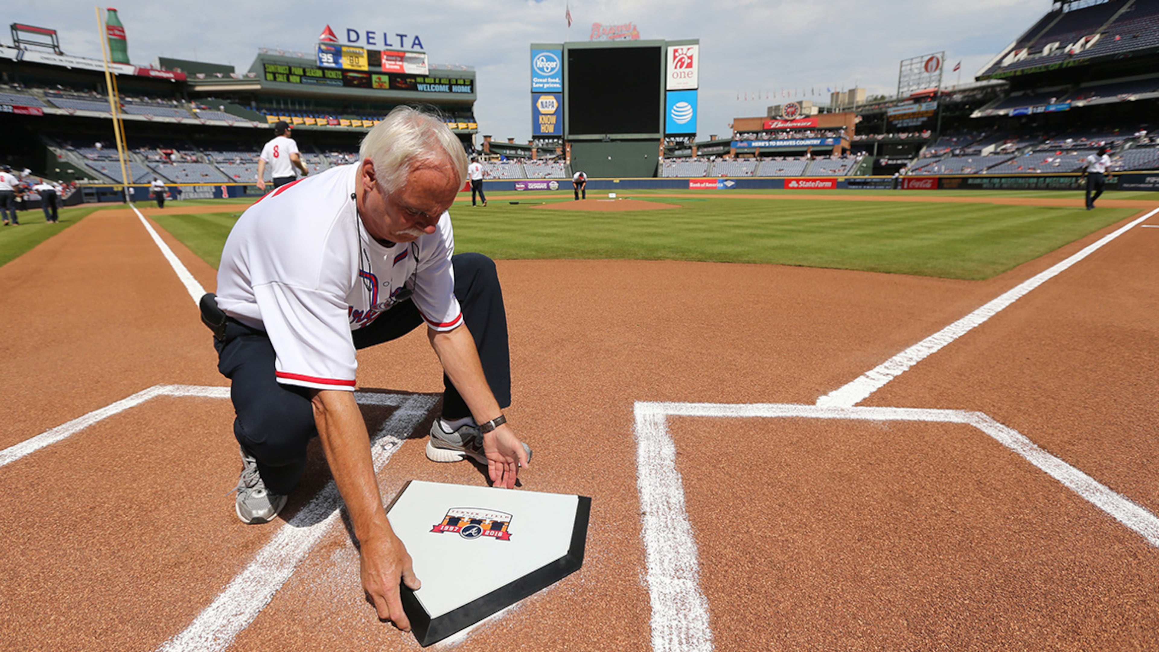 Ground crew member Kim Bode installs the special home plate for the final Braves game at Turner Field on Sunday, Oct. 2, 2016, in Atlanta. The home plate will be moved in a game ending ceremony to the new stadium in Cobb County.
