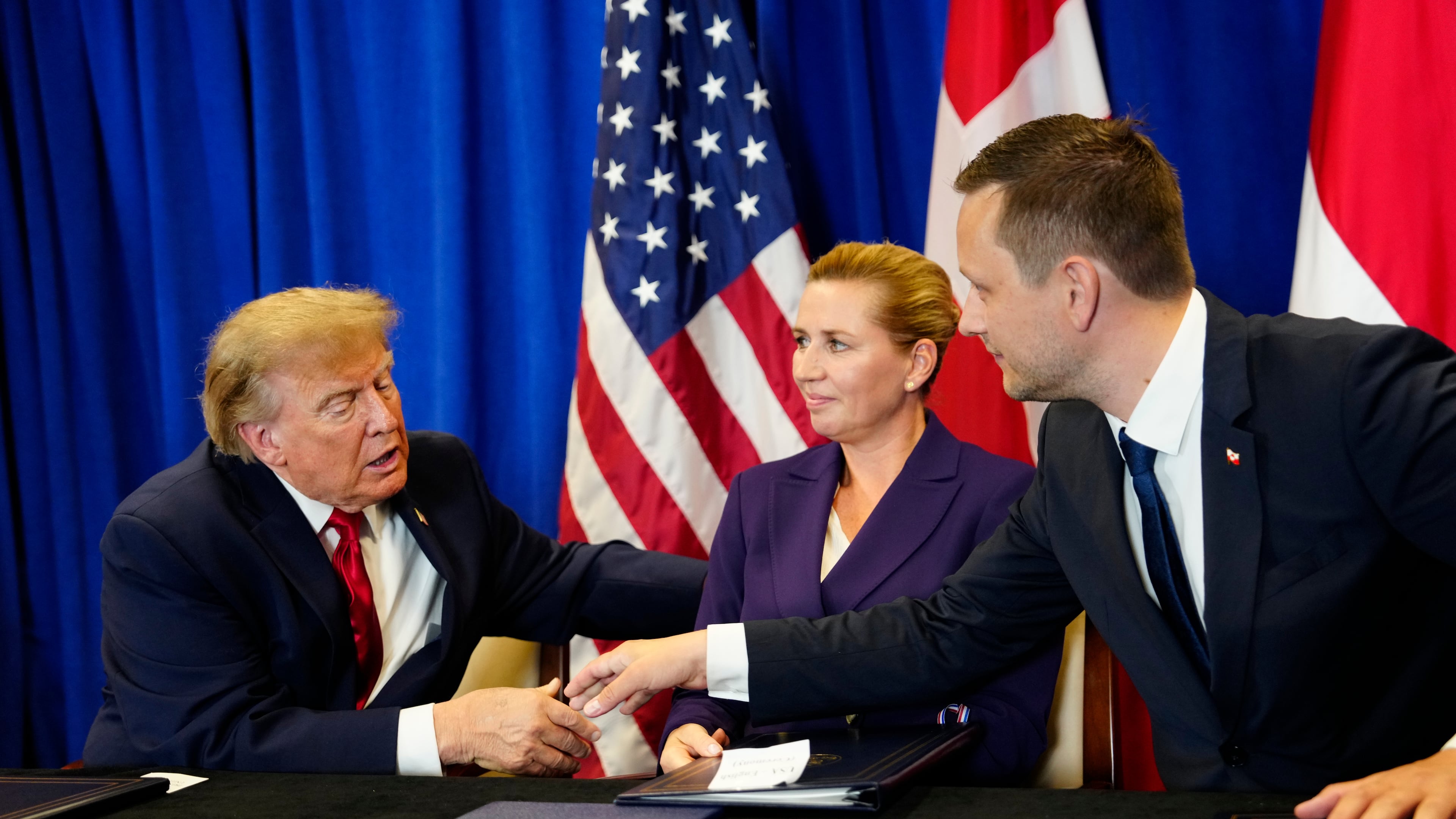 Denmark's Prime Minister Mette Frederiksen, center, Greenland's Prime Minister Jens-Frederik Nielsen, right, and US President Donald Trump at the signing ceremony of a security deal between the U.S., Denmark and Greenland at United Nations headquarters, Tuesday, Sept. 22, 2026. (Mads Claus Rasmussen/Ritzau Scanpix via AP)