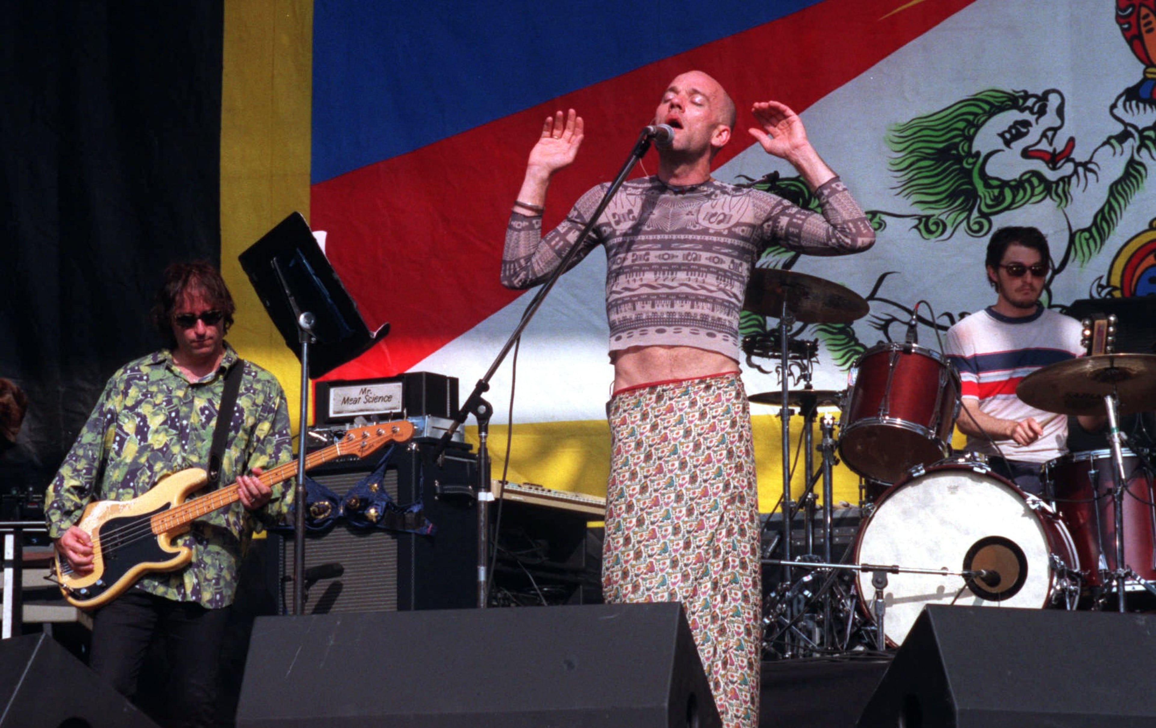 Michael Stipe of R.E.M. sings to the crowd gathered at RFK Stadium in Washington, Sunday, June 14, 1998, as the band performs during the Tibetan Freedom Festival. The concert featuring some of the world's top rock bands performed to advocate freedom for Tibet. (AP Photo/Ken Cedeno)