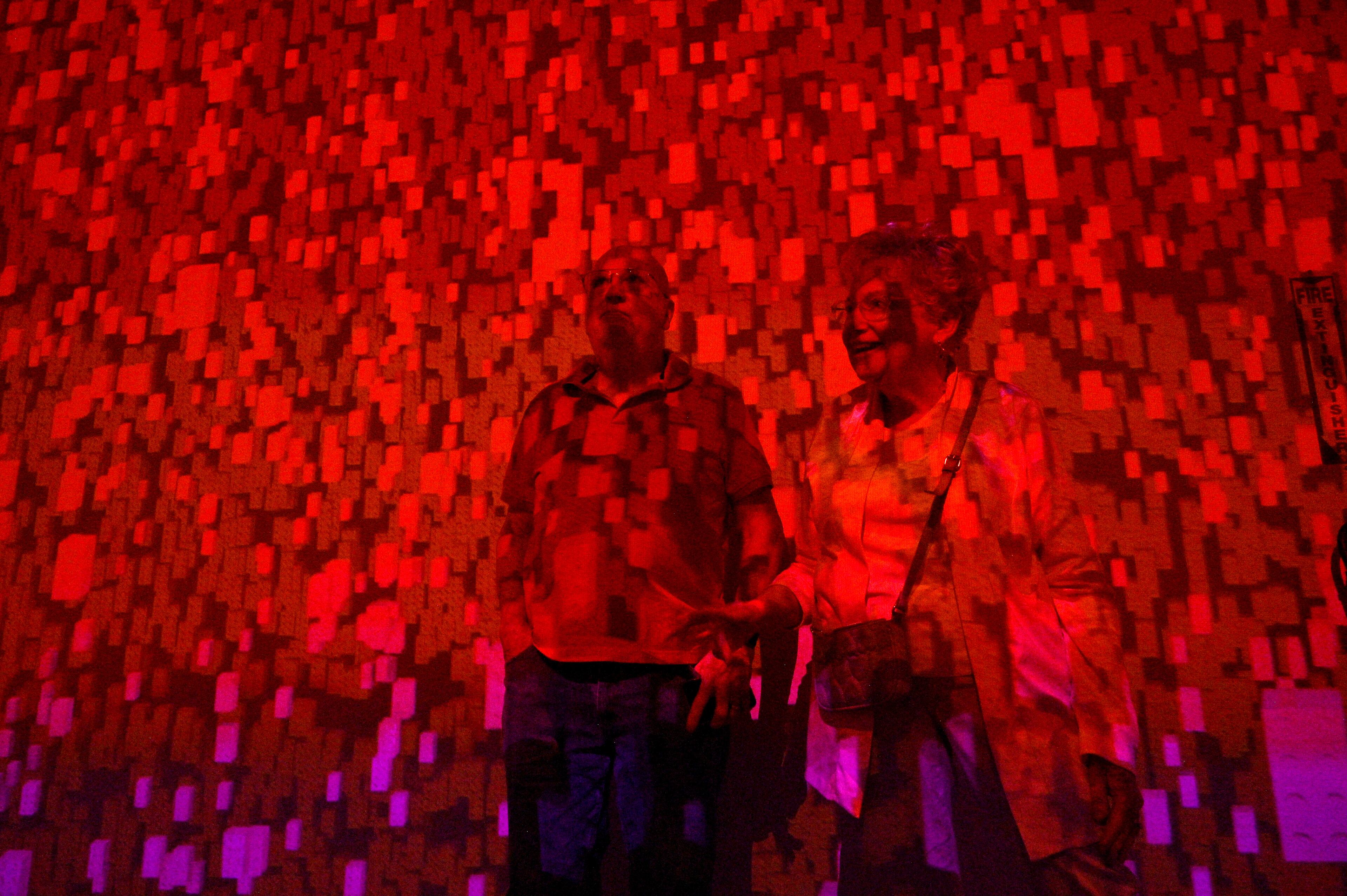 Arlene and George Shemaka of Woodstock react as they enjoy Lego arts at "Art of the Brick Immersive Experience" exhibition at Exhibition Hub Atlanta Art Centre, Wednesday, April 19, 2023, in Doraville. The exhibition will feature many pieces and themes, including a room with oversized sculptures (25-foot long), over 70 works of art crafted from more than 1 million LEGO bricks, galleries celebrating human-kind and nature, and a short documentary about how Nathan creates his works. (Hyosub Shin / Hyosub.Shin@ajc.com)