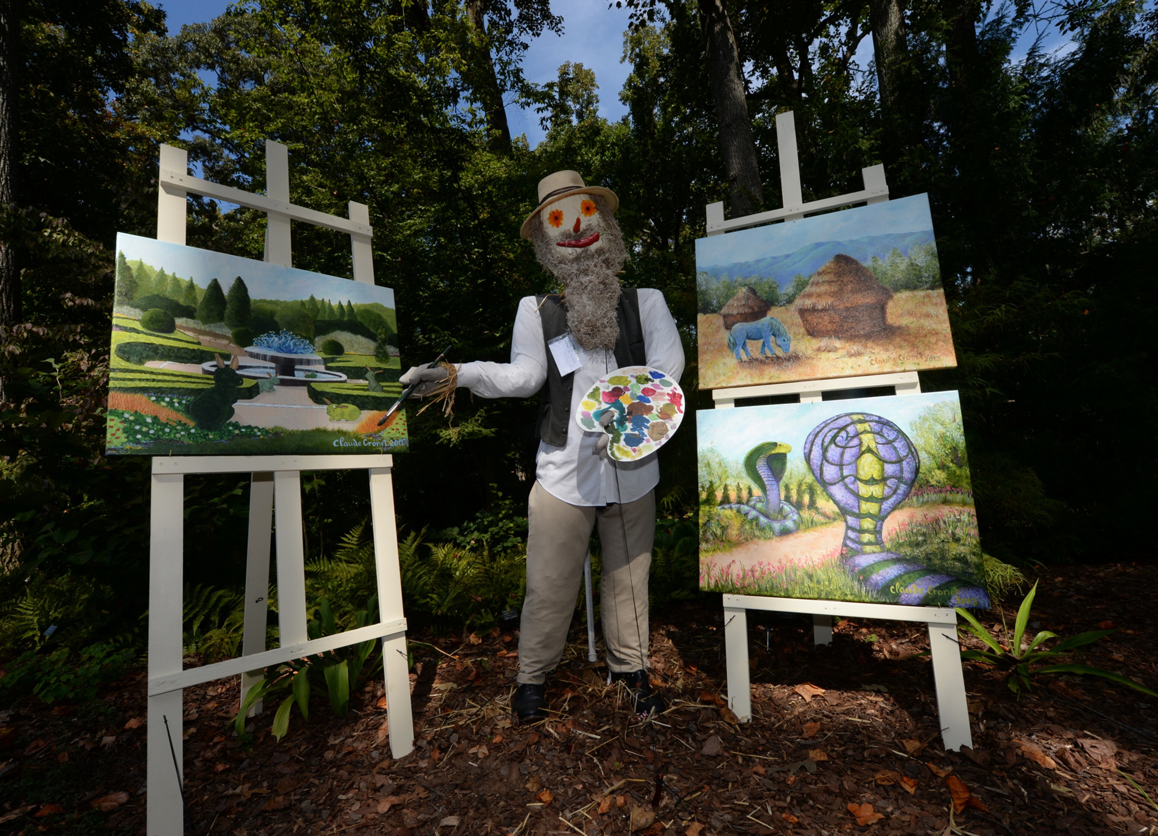 This piece entitled The Crow-nies was one of the many scarecrows that incorporated life plant creatures of Imaginary Worlds in their exhibit at the Atlanta Botanical Garden on Wednesday, October 2, 2013. This was one of over 125 scarecrows hand crafted by businesses, individuals, schools and organizations. The creative scarecrows share the stage with the larger than life plant creatures of Imaginary Worlds. JOHNNY CRAWFORD / JCRAWFORD@AJC.COM JOHNNY CRAWFORD / JCRAWFORD@AJC.COM