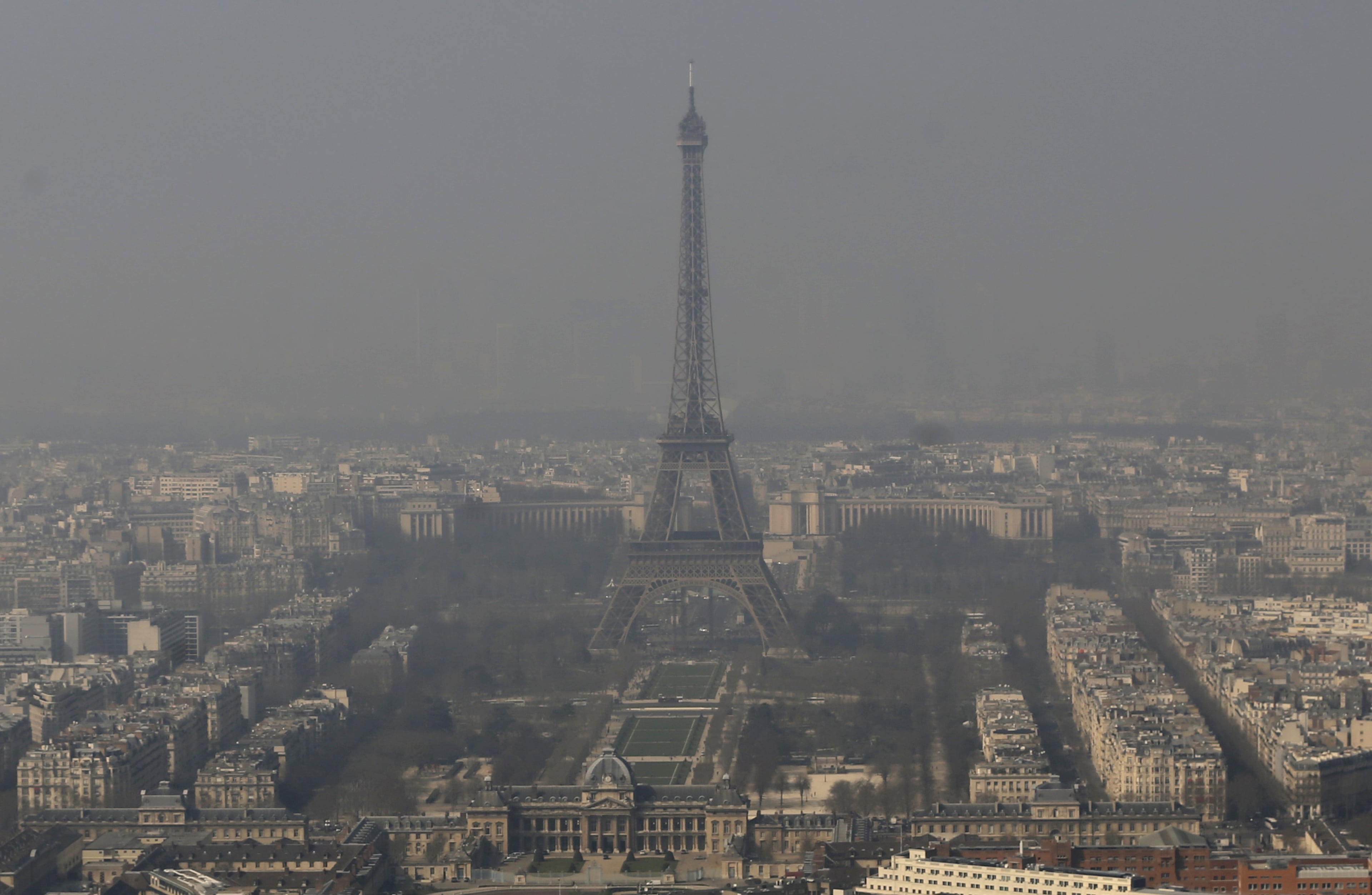 The Eiffel Tower, is barely seen through the smog from Paris, Friday, March 14, 2014. Air pollution that has turned Paris skies a murky yellow is giving a break to millions of French travelers -- public transportation in the Paris region and two other cities is free for the next three days. Nearly three-quarters of France is under alert in what the European Environment Agency says is the worst air pollution since 2007.