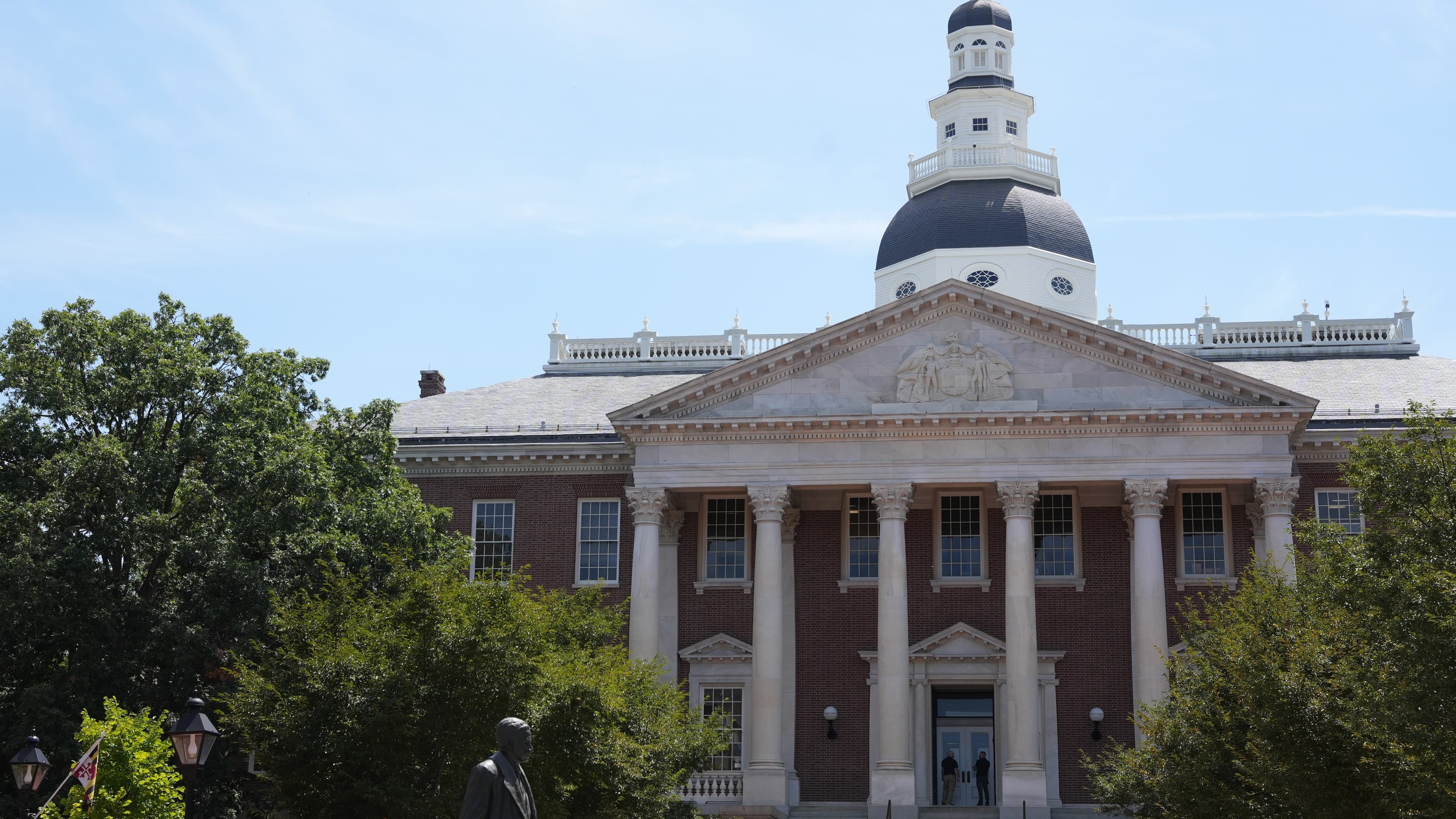 People stand at the doors of the Maryland State House on Tuesday, Aug. 4, 2026, in Annapolis, Md. (AP Photo/Mingson Lau)