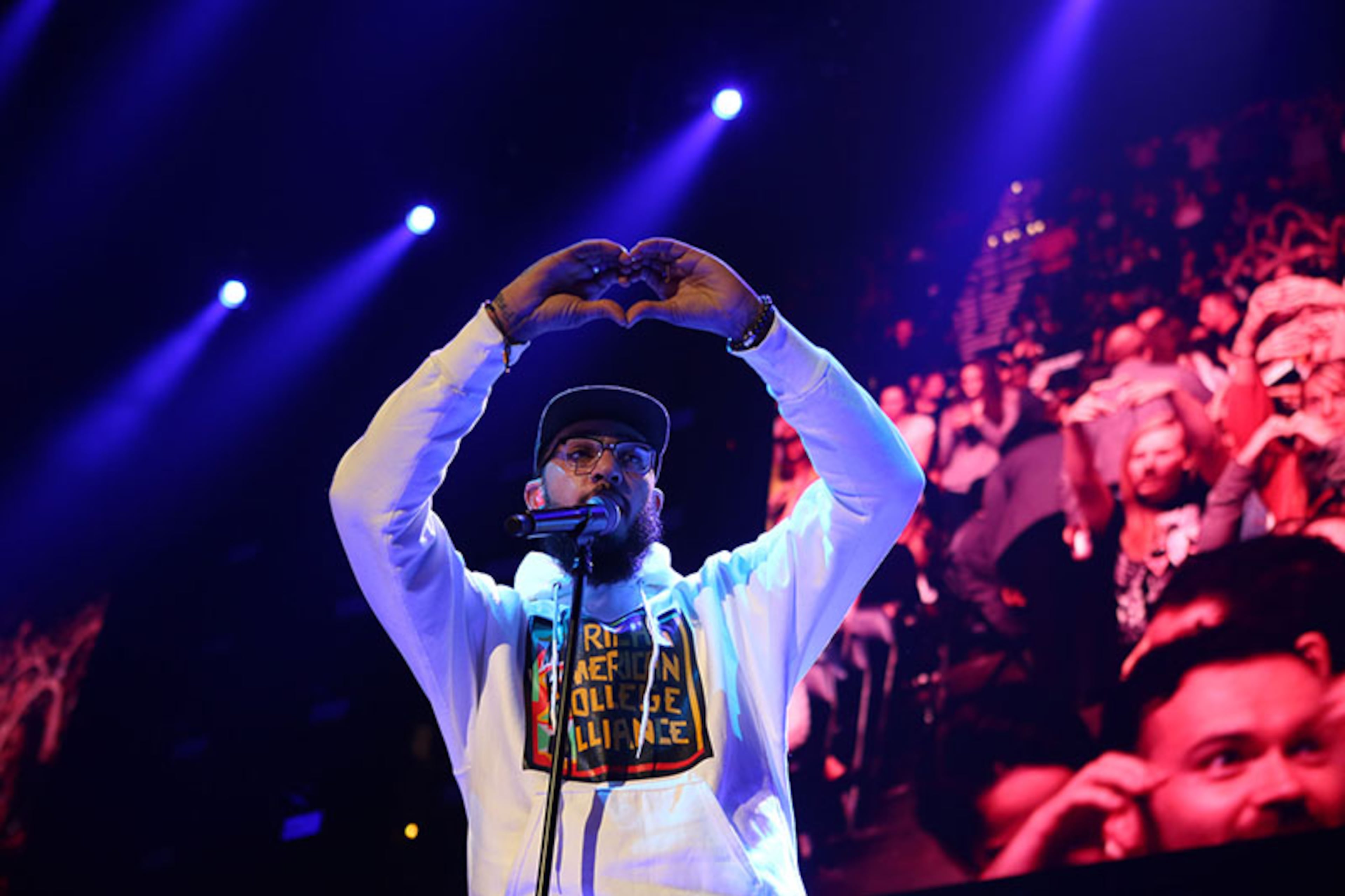 Travie McCoy exhorts the nearly sold-out Philips Arena crowd to make the sign of the heart.
