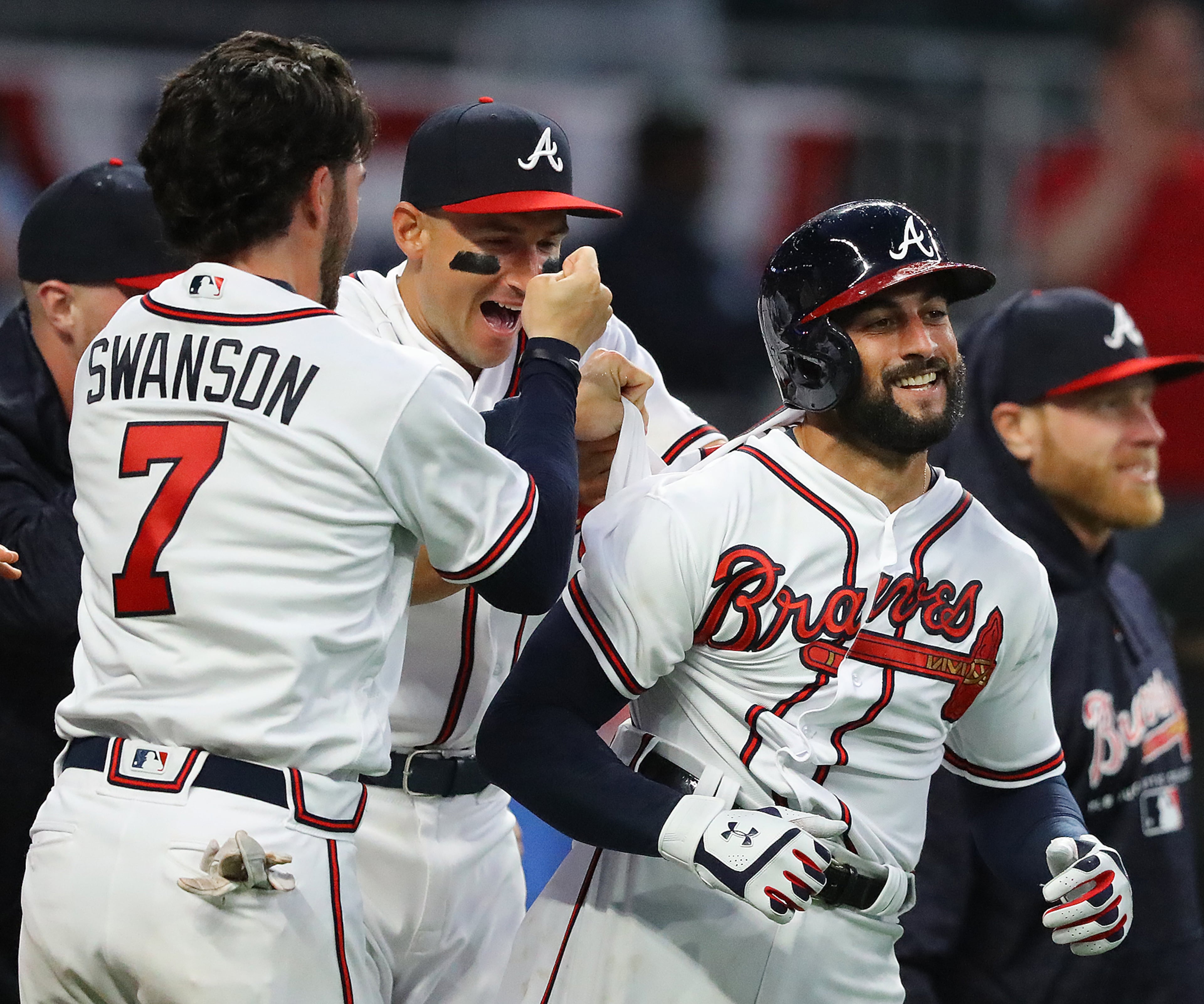 March 29, 2018 Atlanta: Atlanta Braves outfielder Nick Markakis (right) is mobbed by Dansby Swanson and teammates after hitting a walk off 3-RBI home run to beat the Phillies 8 to 5 in a MLB baseball home opening game on Thursday, March 29, 2018, in Atlanta. Curtis Compton/ccompton@ajc.com