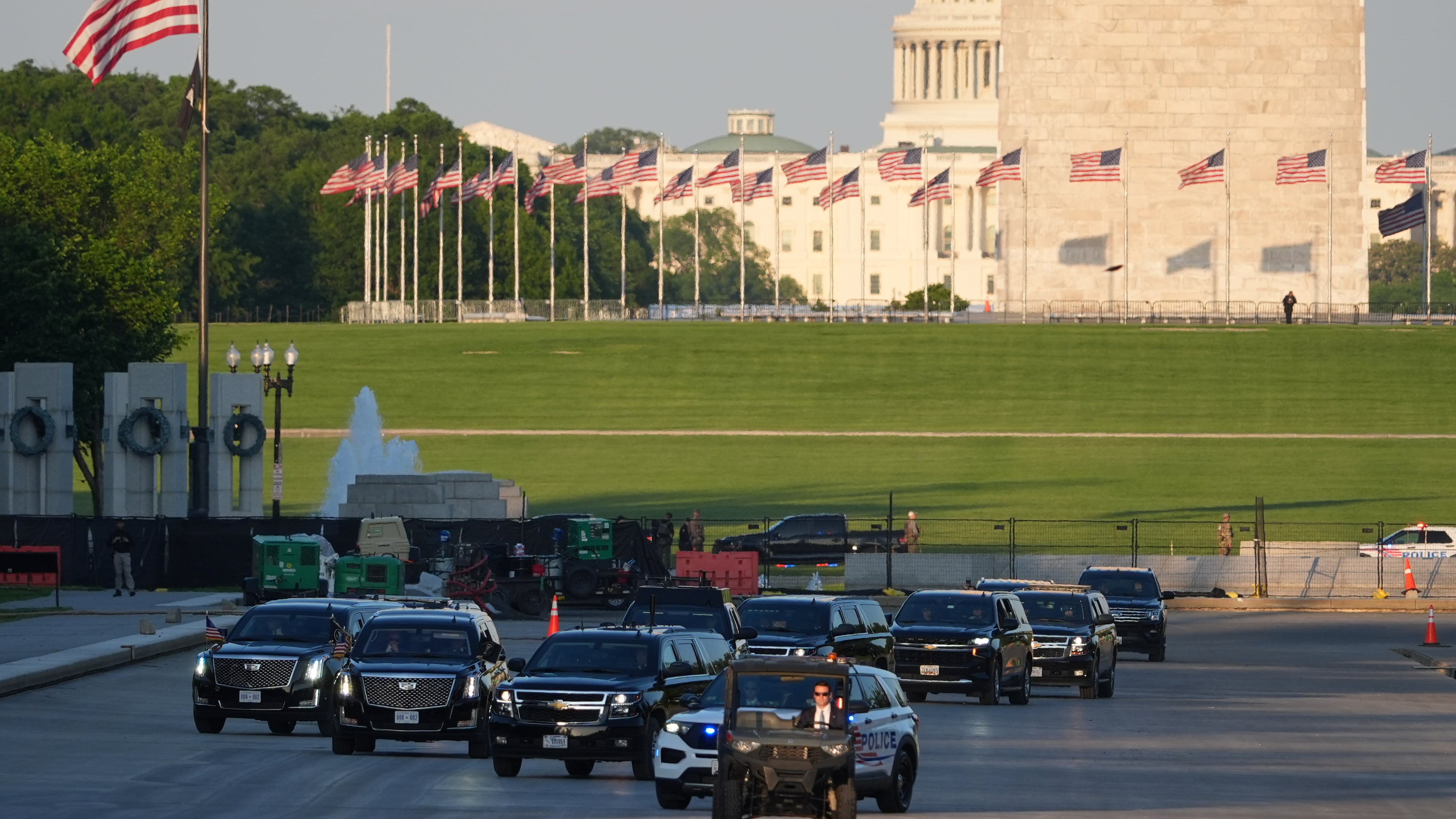 The motorcade with President Donald Trump drives in the Lincoln Memorial Reflecting Pool as he arrives to to see the new blue protective coating being applied as part of a renovation project, Thursday, May 7, 2026, in Washington. (AP Photo/Mark Schiefelbein)