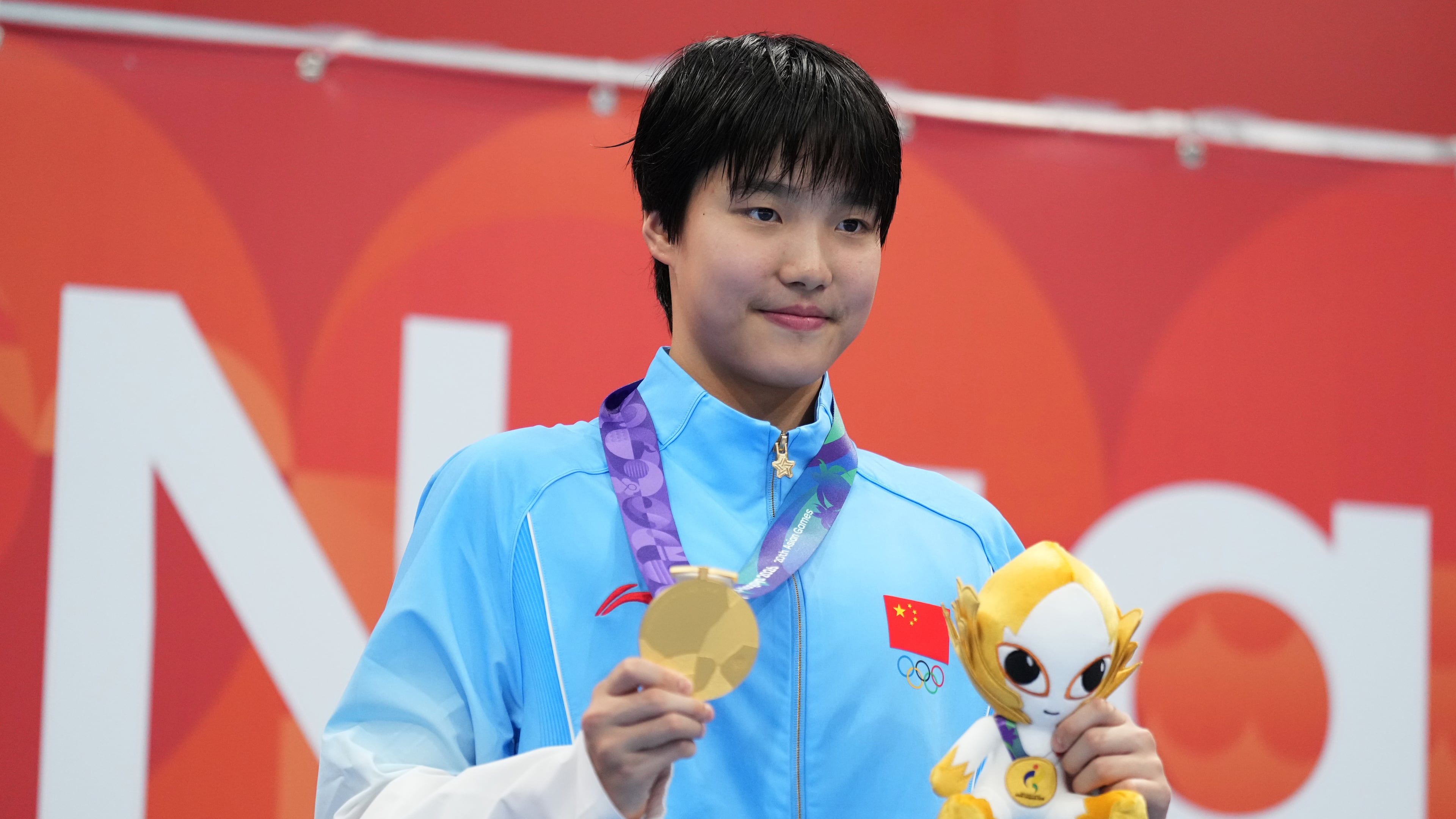 Gold medalist Yu Zidi of China poses on the podium after the women's 200-meter individual medley final in swimming at the Asian Games in Tokyo, Japan, Monday, Sept. 21, 2026. (AP Photo/Hiro Komae)