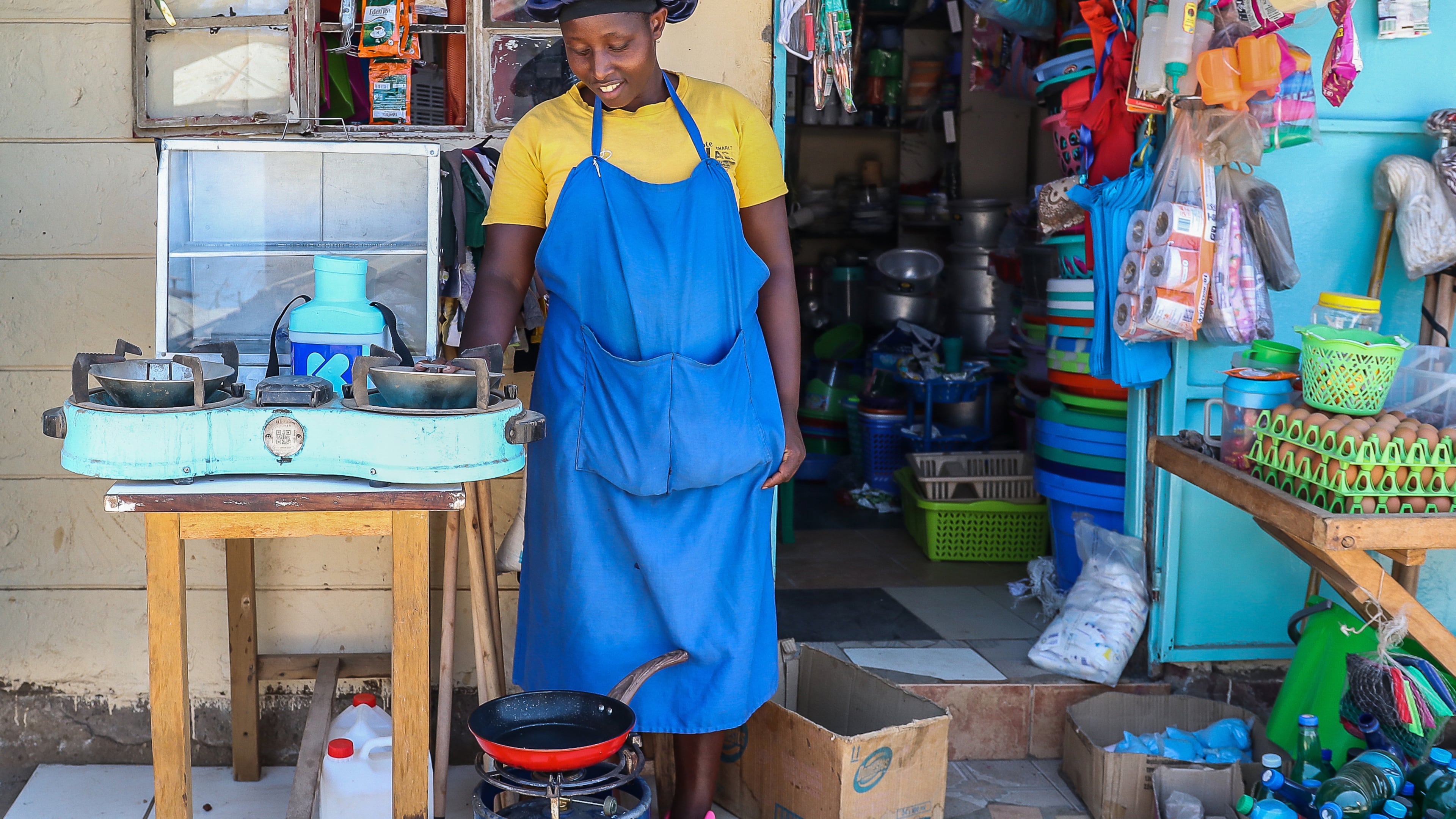 FILE - Grace Kathambi uses a bioethanol fuel stove to fry and sell French fries at her shop in Kibera, an informal settlement on the outskirts of Nairobi, Kenya, on Feb. 4, 2026. (AP Photo/Atieno Muyuyi, File)