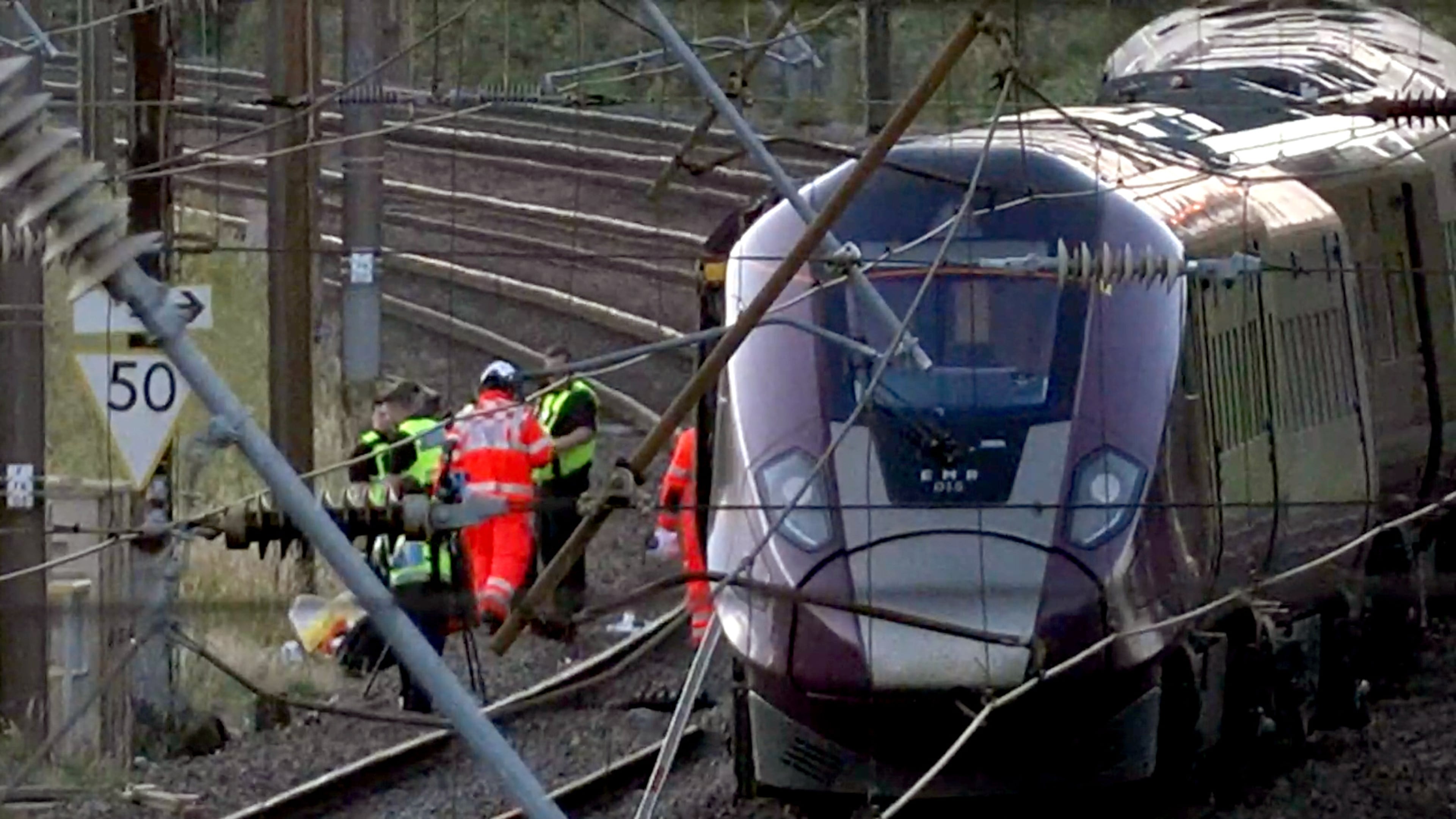 Emergency personnel work on a train on the tracks outside Bedford, England, after a train from Corby to London St. Pancras and another from Nottingham to London St. Pancras, collided on Friday June 19, 2026. (Jamie Lashmar/PA via AP)