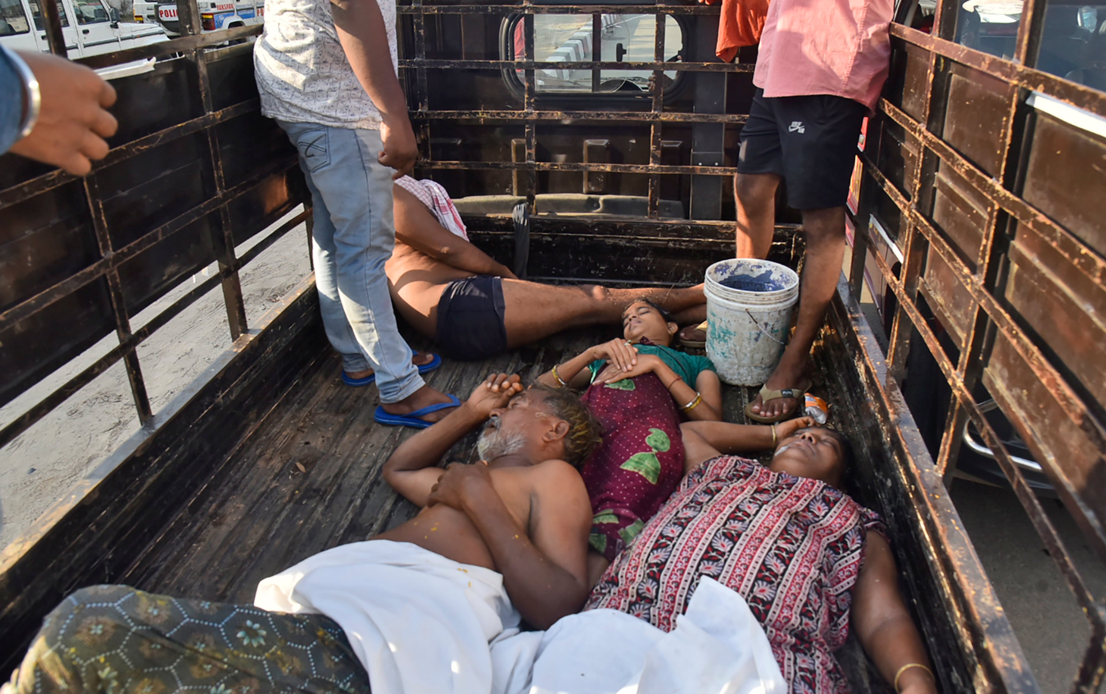 People affected by a chemical gas leak are carried in a truck for medical treatment. Administrator Vinay Chand said several people fainted on the road and were rushed to a hospital.