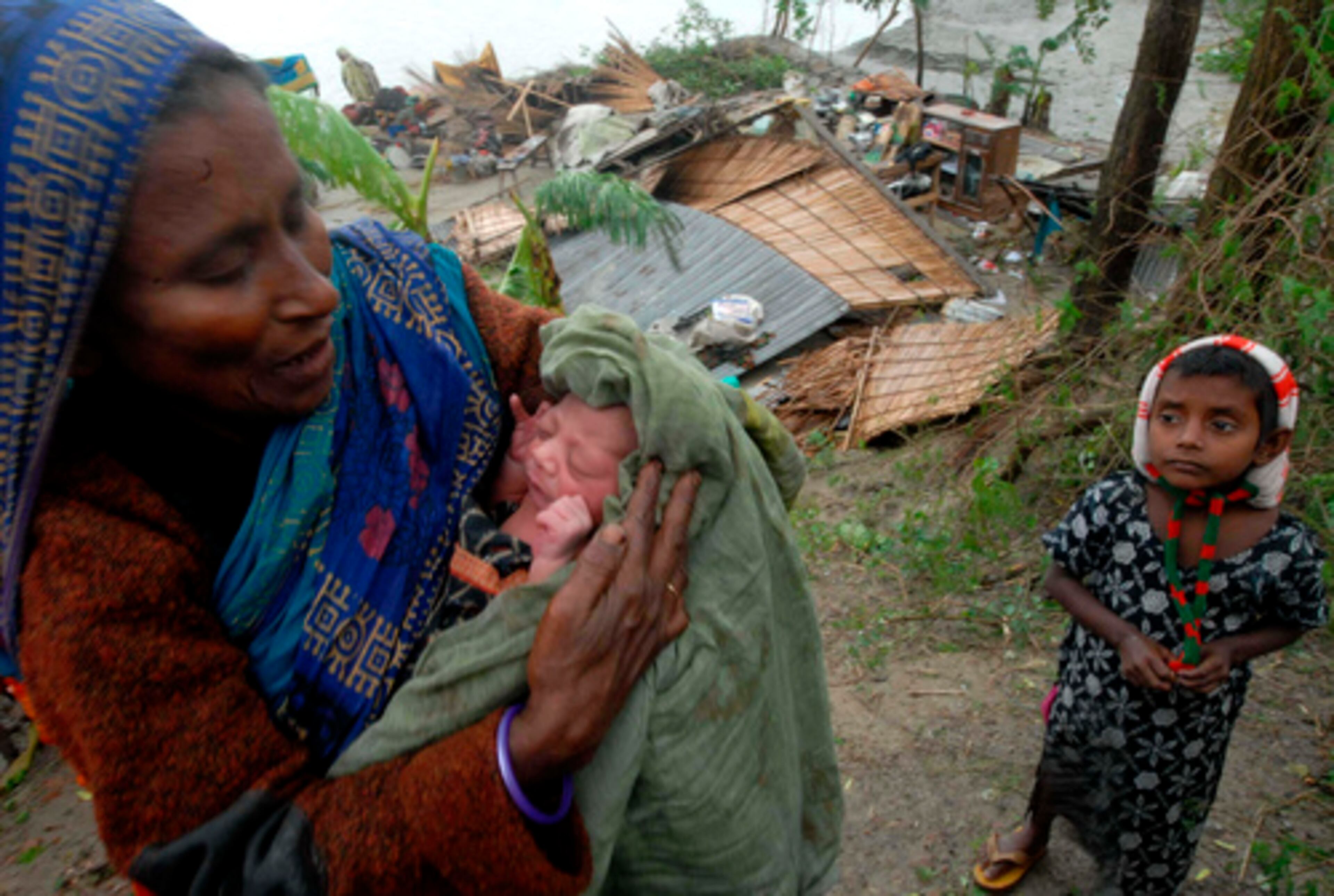 A grandmother holds a newborn baby who was named Cyclone after he was born during the storm in Bangladesh. They live in Barishal, 75 miles south of Bangladesh's capital.