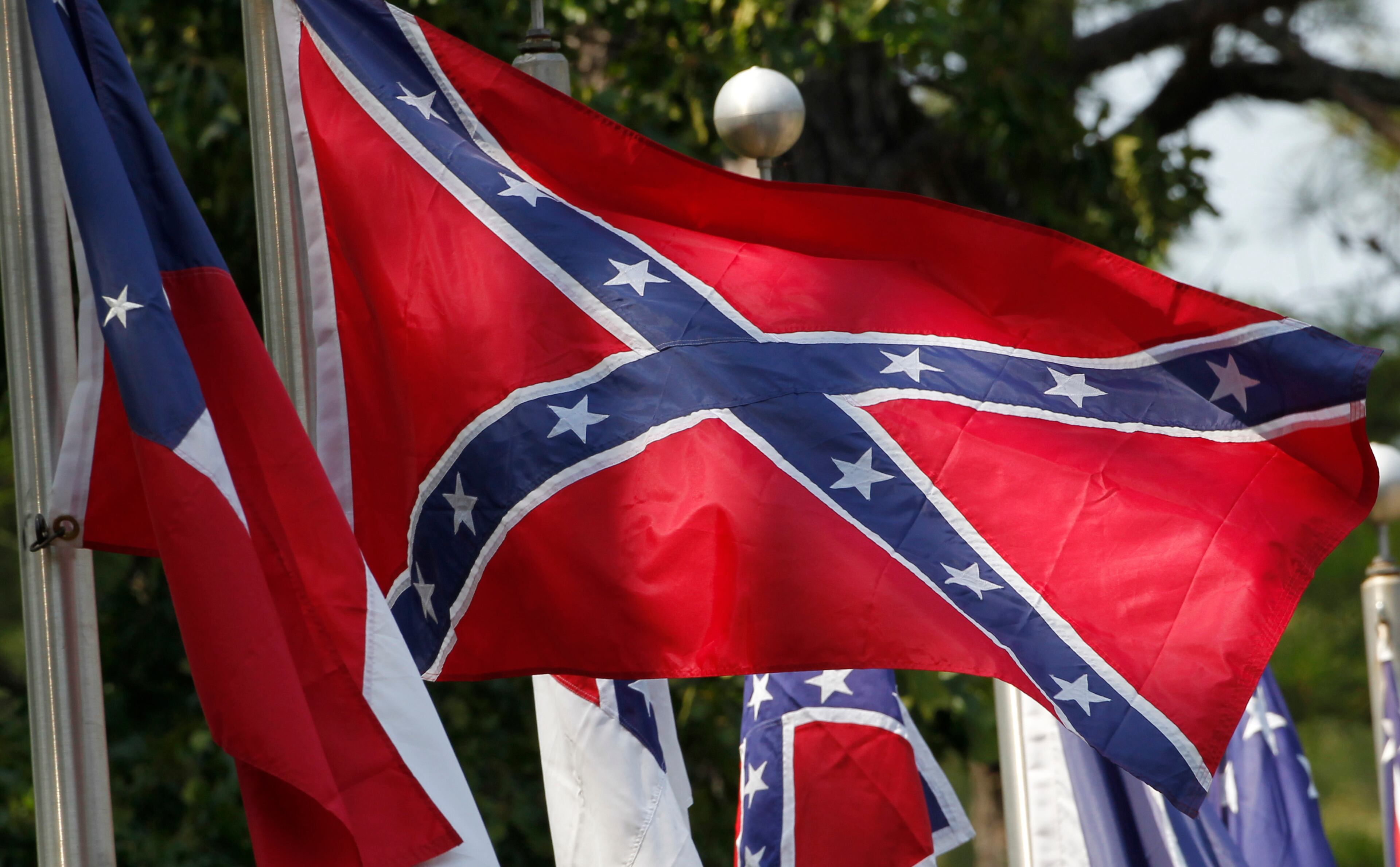 FILE - In this July 19, 2011, file photo, Confederate battle flags fly outside the museum at the Confederate Memorial Park in Mountain Creek, Ala. The Confederate battle flag has been removed from South Carolina's Statehouse grounds, in the wake of the massacre of nine African-Americans, including a state senator, at an historic black church in Charleston in June 2015. (AP Photo/Dave Martin, File)