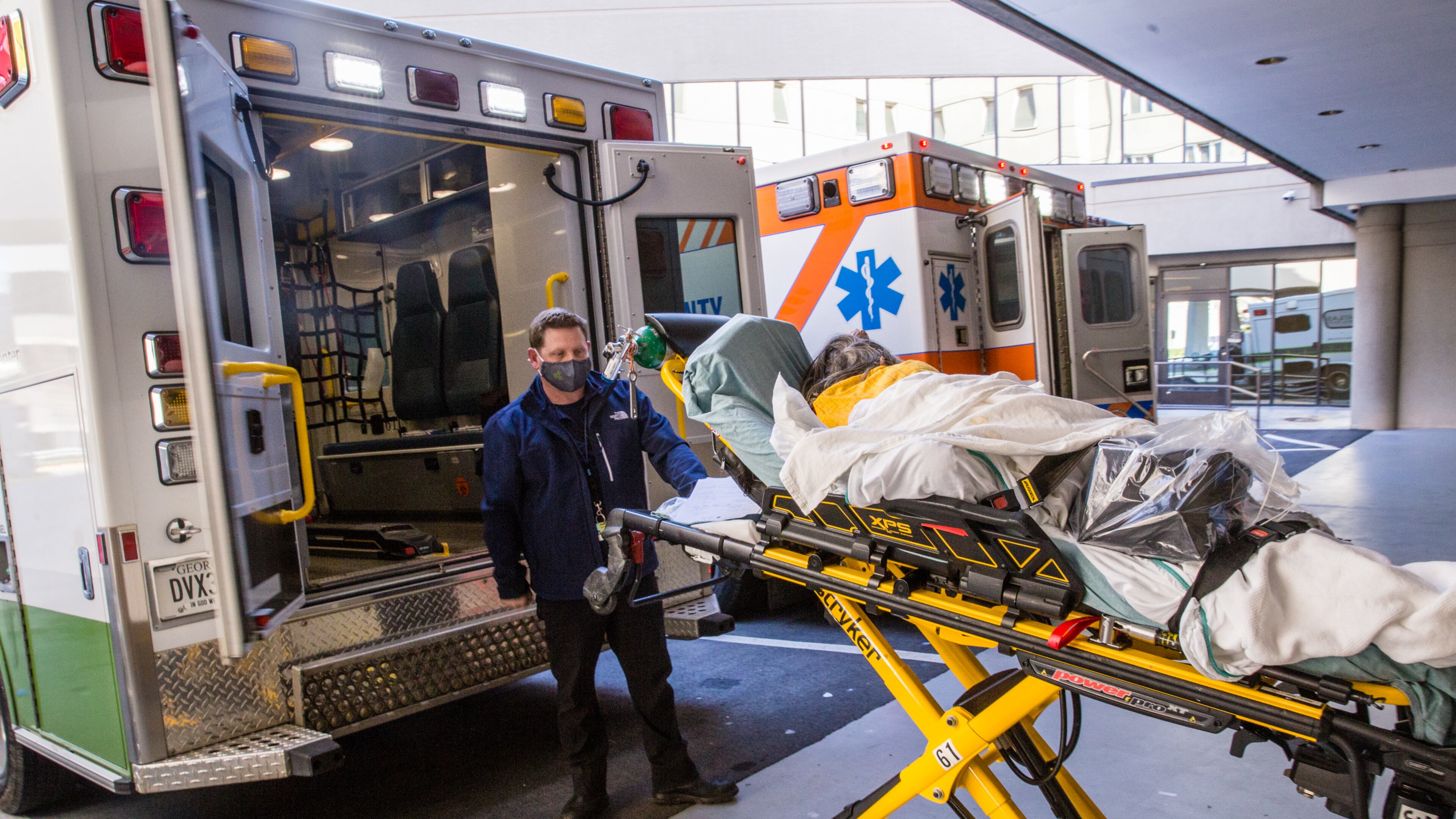 Northeast Georgia Medical Center in Gainesville is dealing with their third surge of Covid cases Thursday, Dec 3, 2020. A Covid patient is transported by ambulance from the main hospital after tests by Jamerson Kerby back to the Mobile Medical Unit created to keep Covid patients apart from the main facility on campus. The hospital system has built multiple spaces to keep Covid patients away from the main hospital, however, more than 100 patients are still in standard hospital beds. The day after Thanksgiving was a record for the hospital in taking Covid patients. (Jenni Girtman for The Atlanta Journal Constitution)