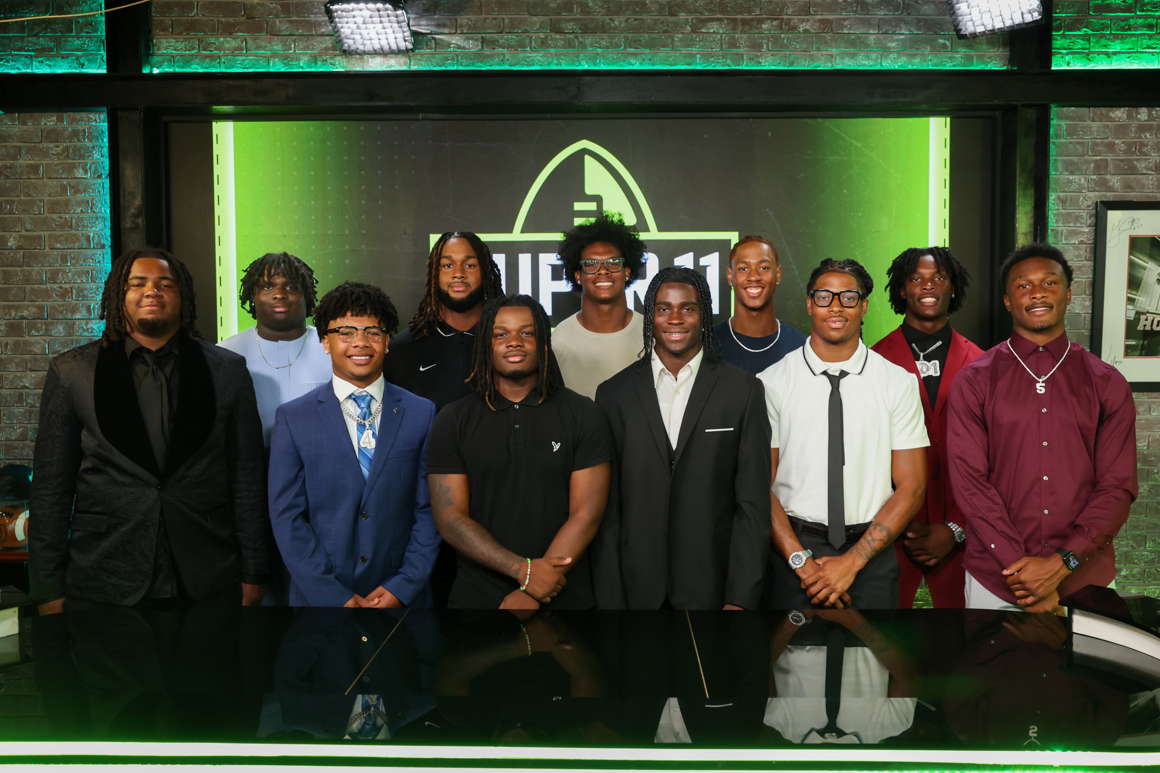 The Super 11 Class of 2026 pose for a portrait at the Super 11 reveal show at Score ATL in Roswell on Aug. 3, 2026. (Arvin Temkar/AJC)