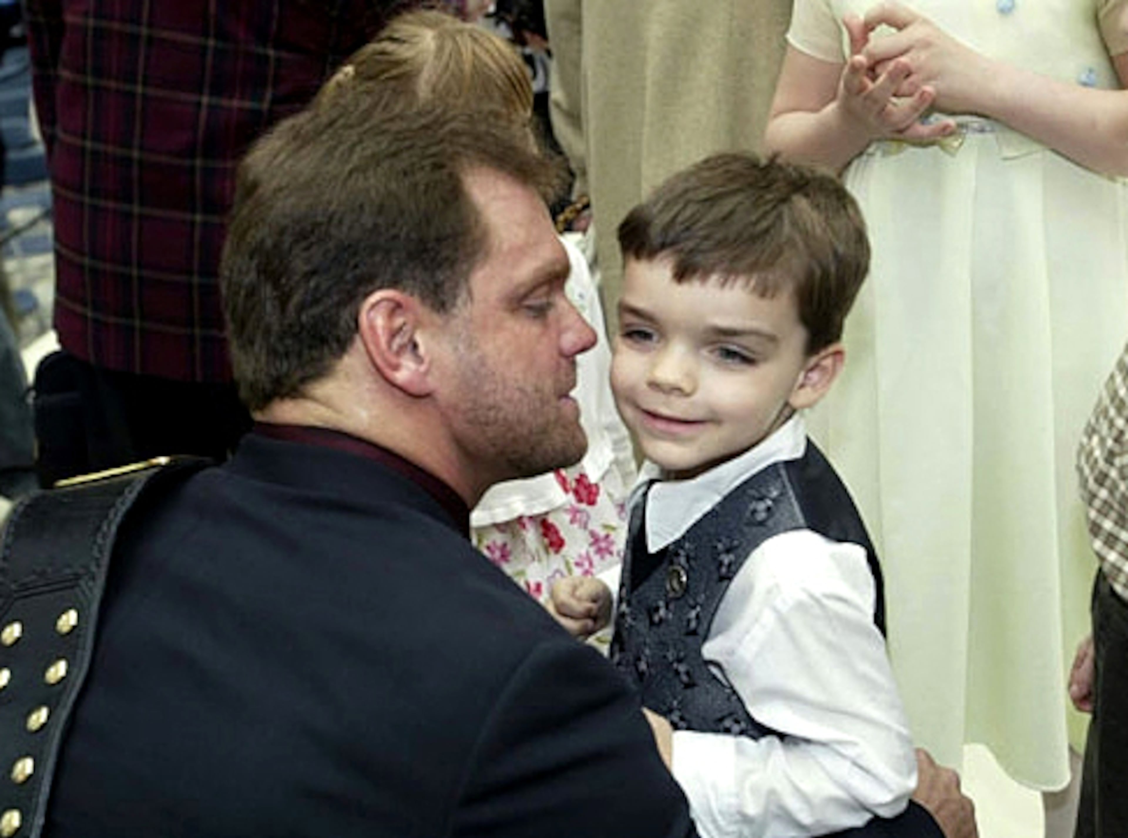 Benoit holds his mentally disabled child son, Daniel, who suffered from a rare medical condition.