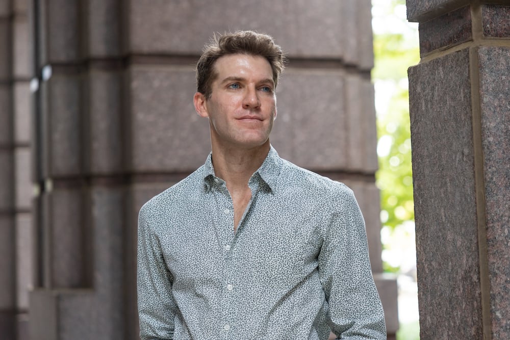 AJC reporter Lautaro Grinspan poses for a portrait outside The Atlanta Journal-Constitution offices in Atlanta earlier this month. (Arvin Temkar/AJC)