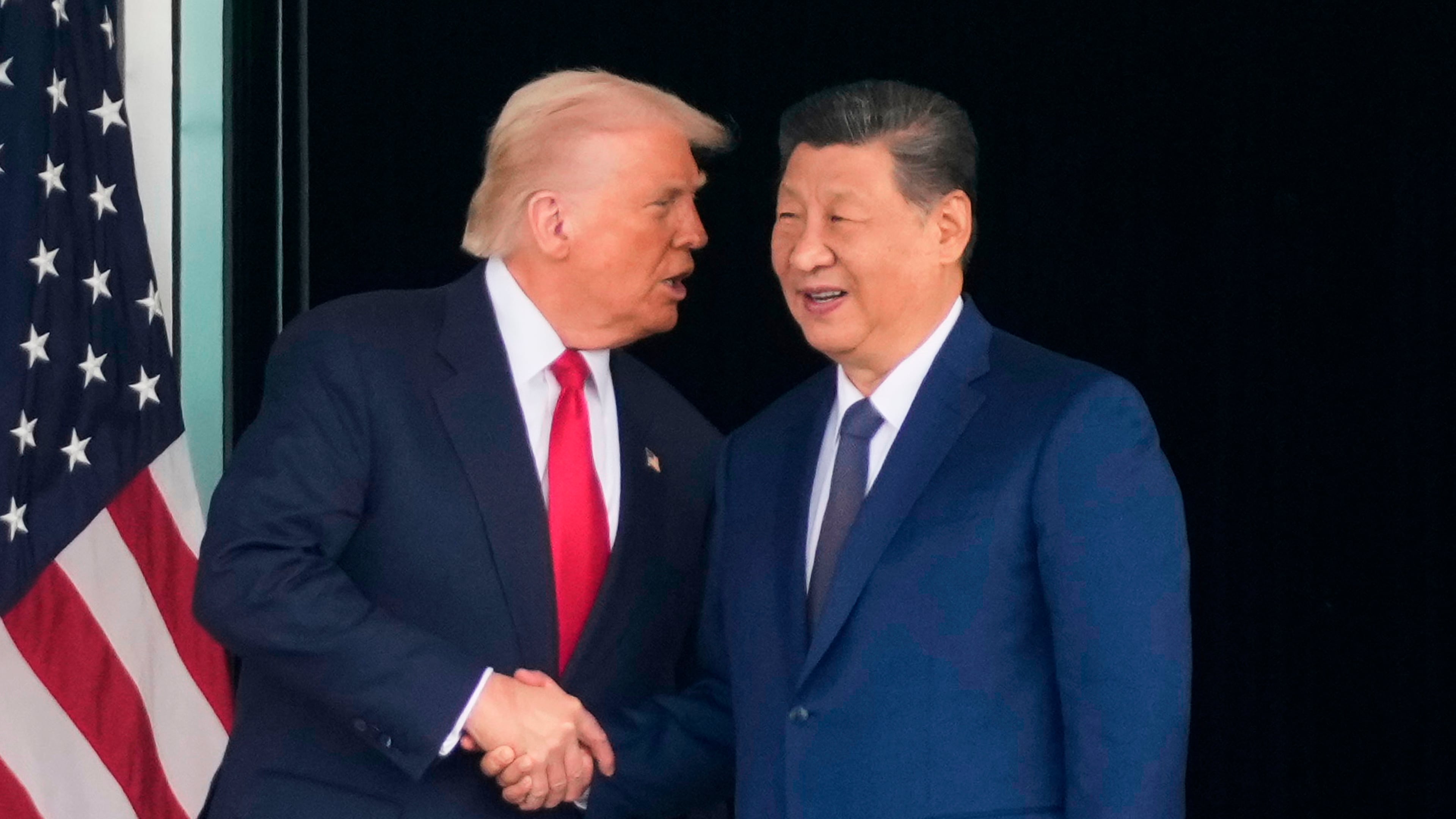 FILE - President Donald Trump, left, and Chinese President Xi Jinping, shake hands after their U.S.-China summit talk at Gimhae International Airport Jinping in Busan, South Korea, Oct. 30, 2025. (AP Photo/Mark Schiefelbein, File)