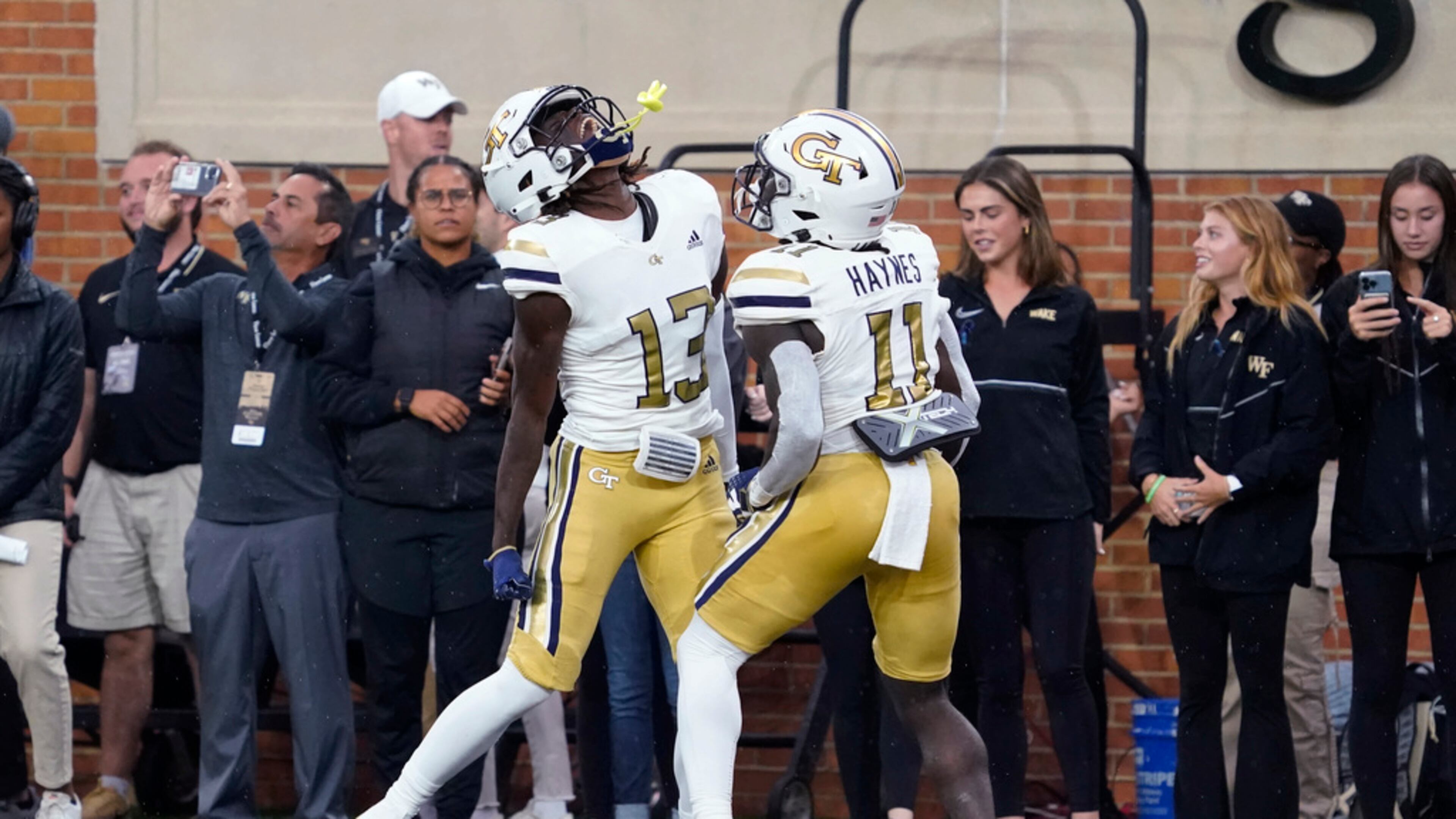 Georgia Tech wide receiver Eric Singleton Jr. (13) celebrates his touchdown catch against Wake Forest with Jamal Haynes (11) during the first half of an NCAA college football game in Winston-Salem, N.C., Saturday, Sept. 23, 2023. (AP Photo/Chuck Burton)