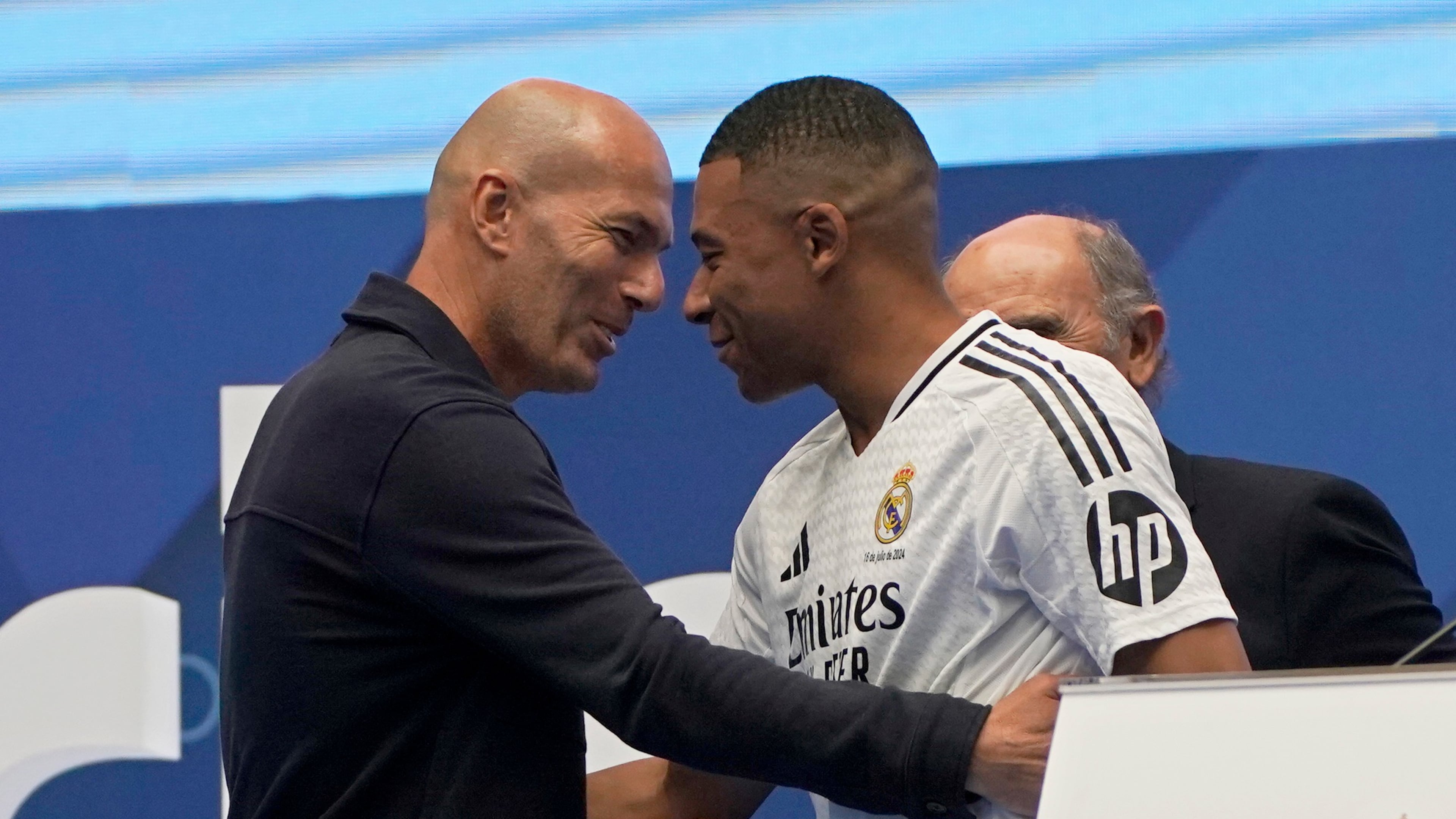 FILE - Former French player Zinedine Zidane, left, embraces Kylian Mbappe of France, as he is being presented to fans as a new Real Madrid player in Madrid, July 16, 2024. (AP Photo/Andrea Comas, File)