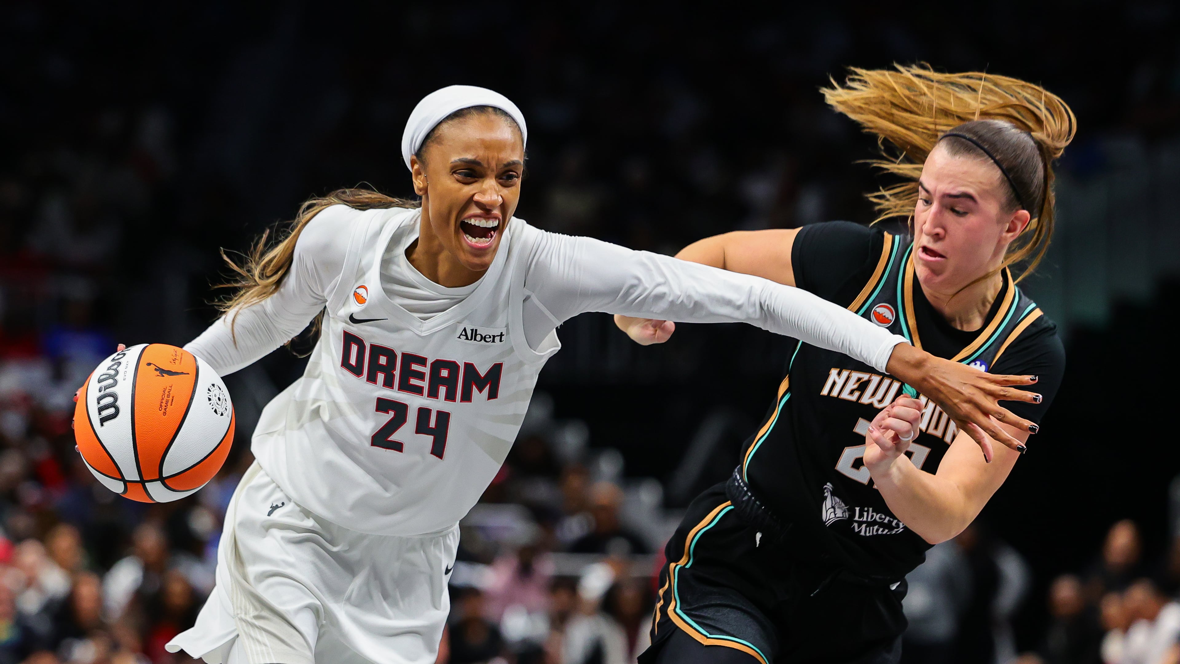 Atlanta Dream forward DeWanna Bonner (24) drives to the basket against New York Liberty guard Sabrina Ionescu, right, during the first half of Game 1 of the WNBA basketball semifinals Sunday, Oct. 4, 2026, in Atlanta. (AP Photo/Colin Hubbard)