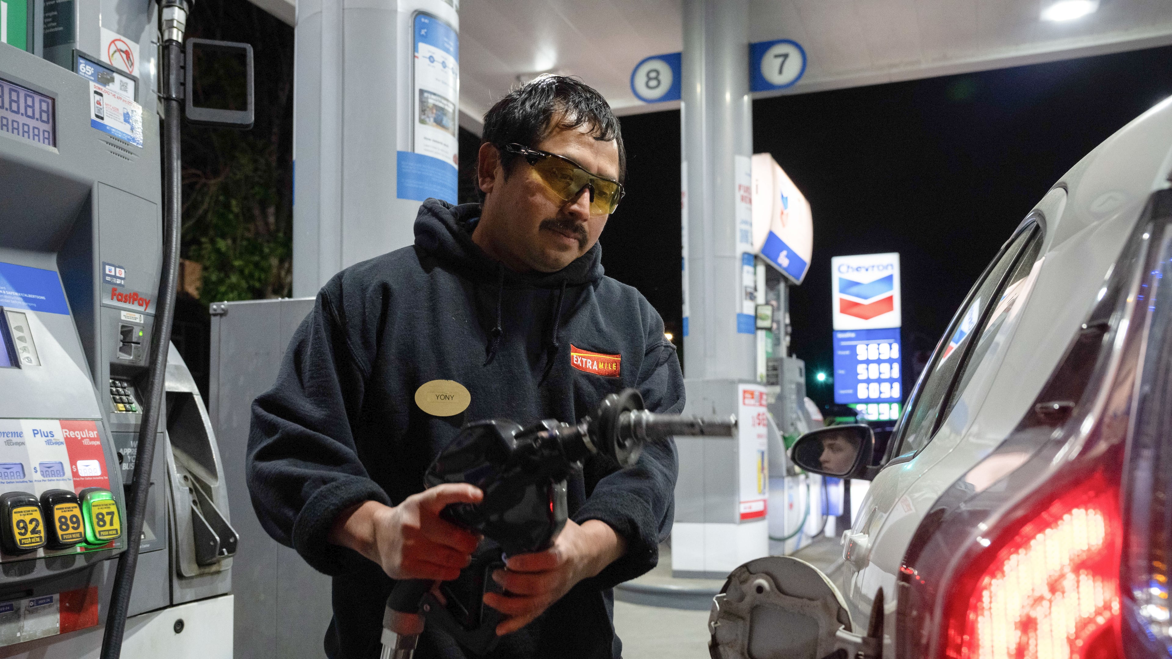 An attendant prepares to fill a customers tank at a gas station on Wednesday, May 6, 2026, in Portland, Ore. (AP Photo/Jenny Kane)