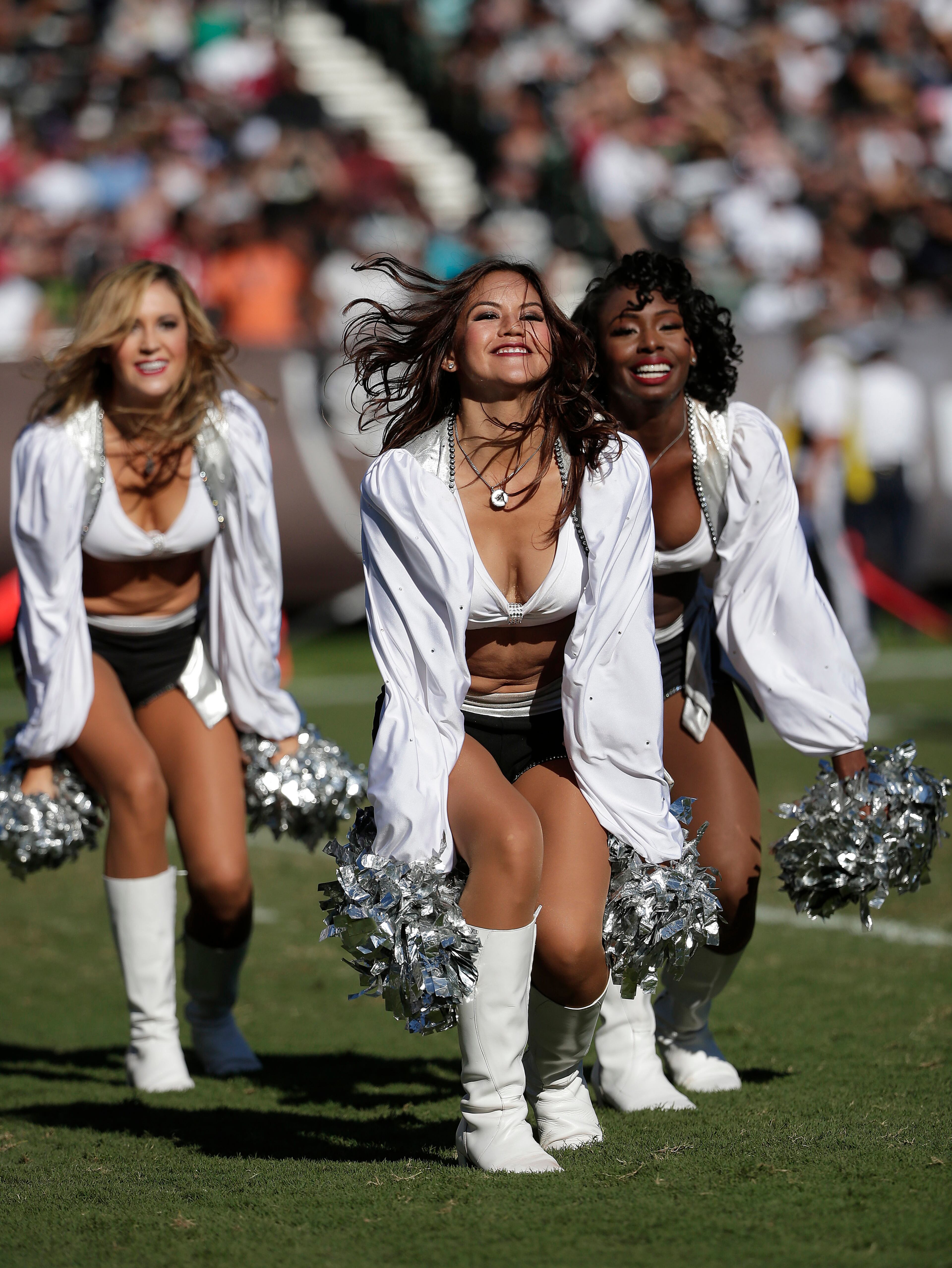 Oakland Raiders cheerleaders perform during the second half of an NFL football game between the Raiders and the Arizona Cardinals in Oakland, Calif., Sunday, Oct. 19, 2014. (AP Photo/Marcio Jose Sanchez)