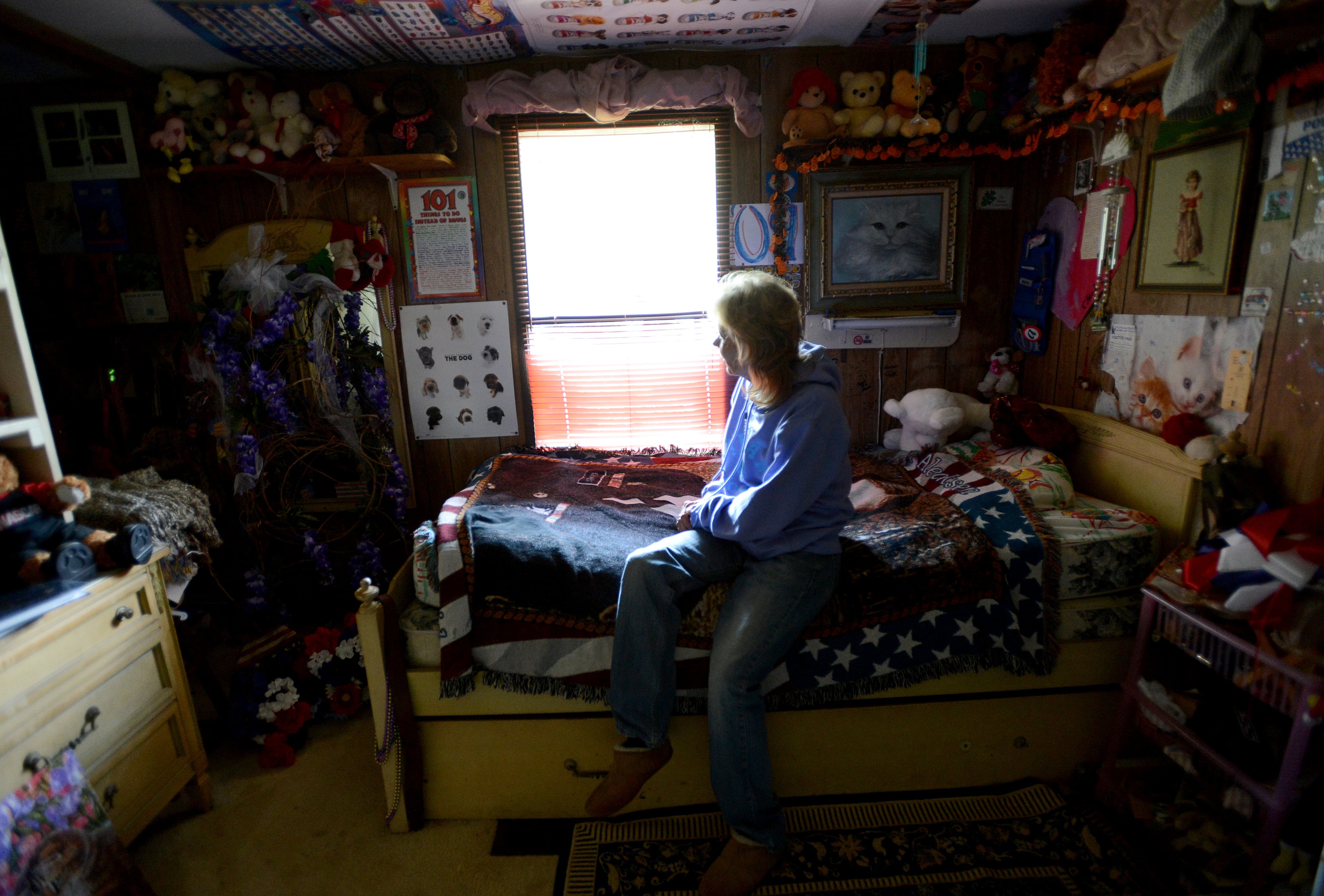 Doria Alecksen sits on the bed in the empty room of her late daughter Erica. Erica's bedroom has hardly been touched since her death July 8. Doria said she'll clean out some of its contents one day--but not just yet.