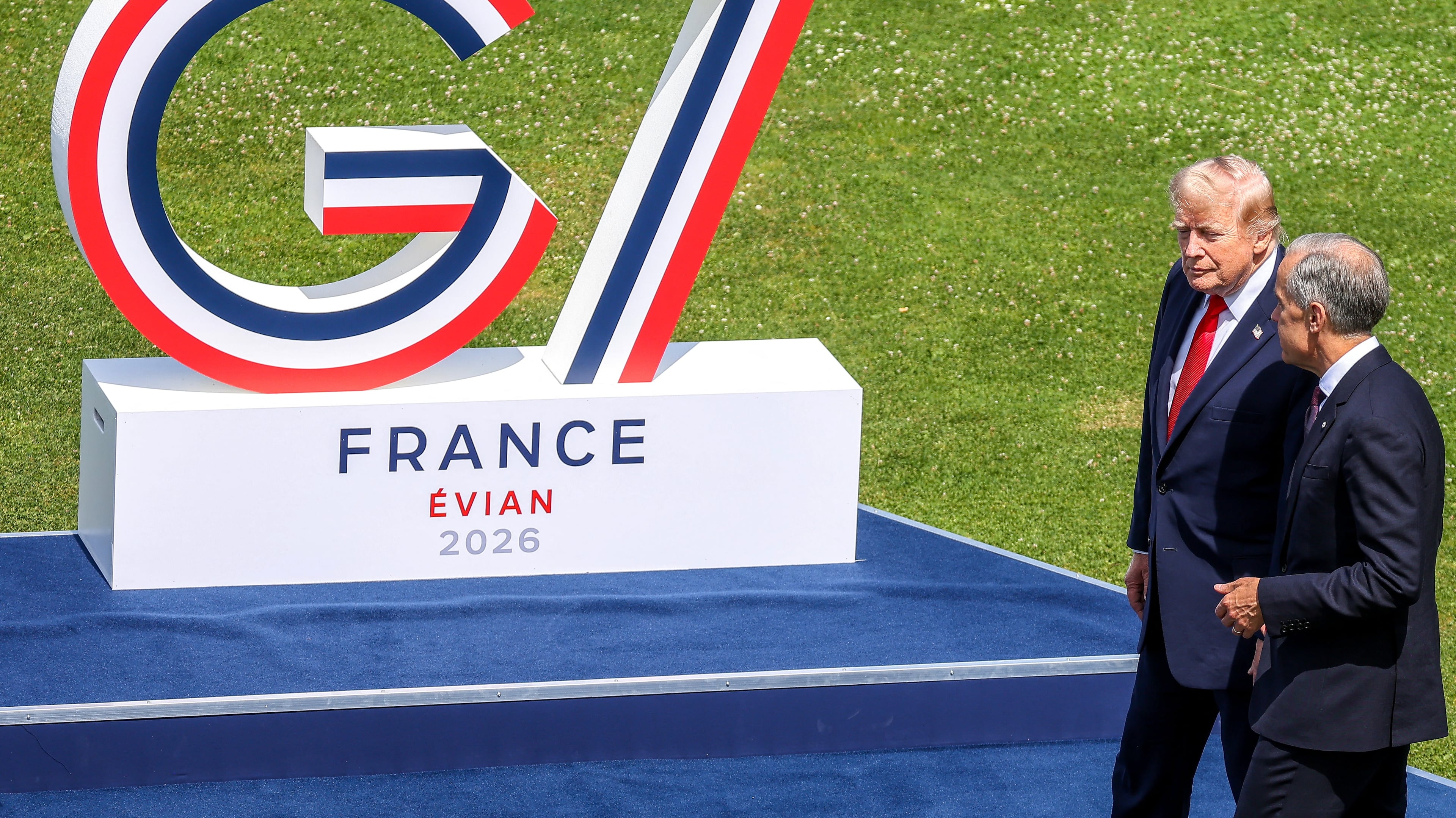 U.S. President Donald Trump, left, speaks with Canadian Prime Minister Mark Carney prior to a group photo of G7 leaders and invited nations during the G7 summit in Evian-les-Bains, France, Tuesday, June 16, 2026. (Dominique Jacovides, Pool Photo via AP)