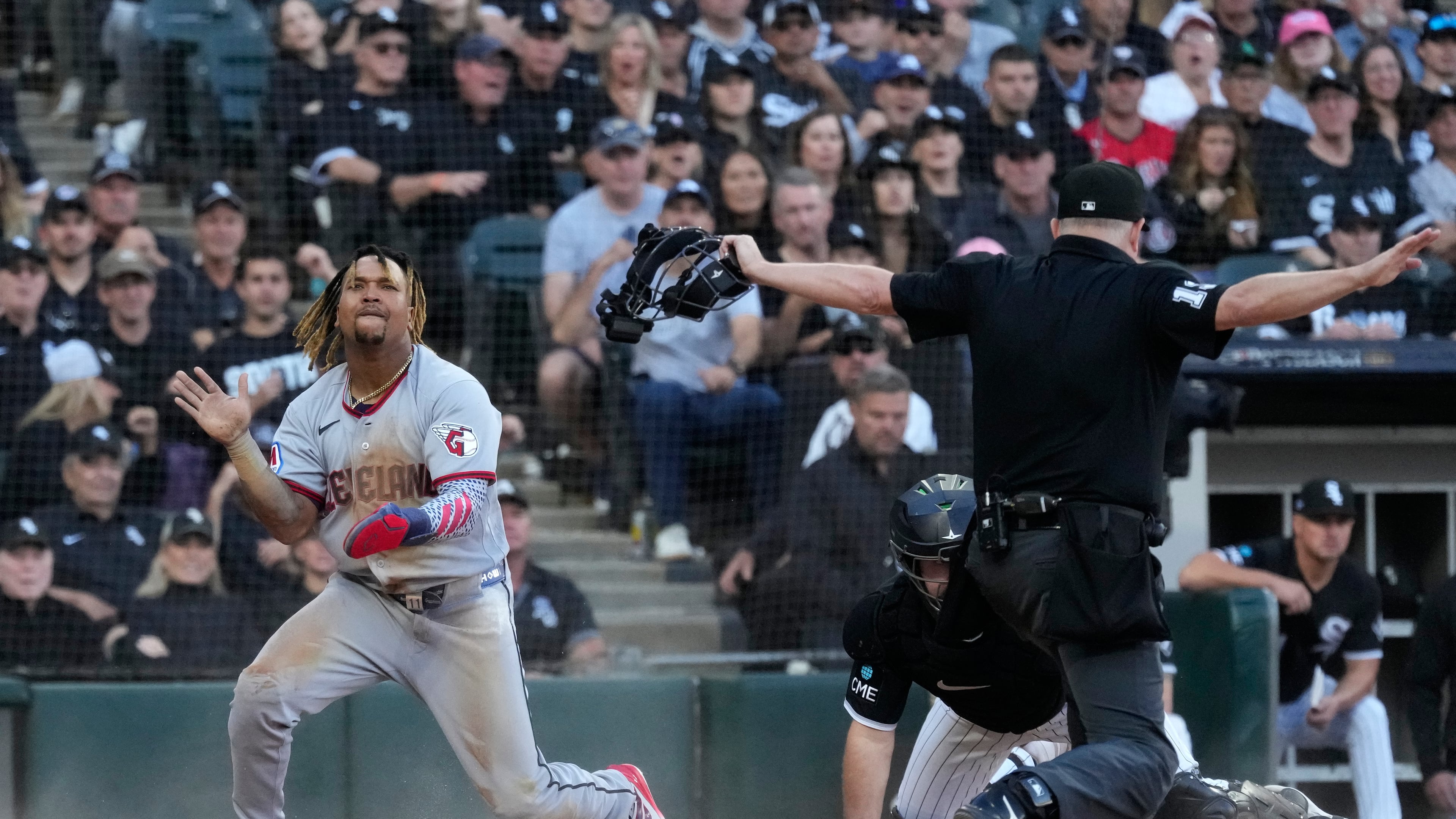 Cleveland Guardians' José Ramírez, left, celebrates after scoring on a fielder's choice by Chase DeLauter during the fifth inning in Game 3 of baseball's American League Division Series against the Chicago White Sox Wednesday, Oct. 7, 2026, in Chicago. (AP Photo/Nam Y. Huh)