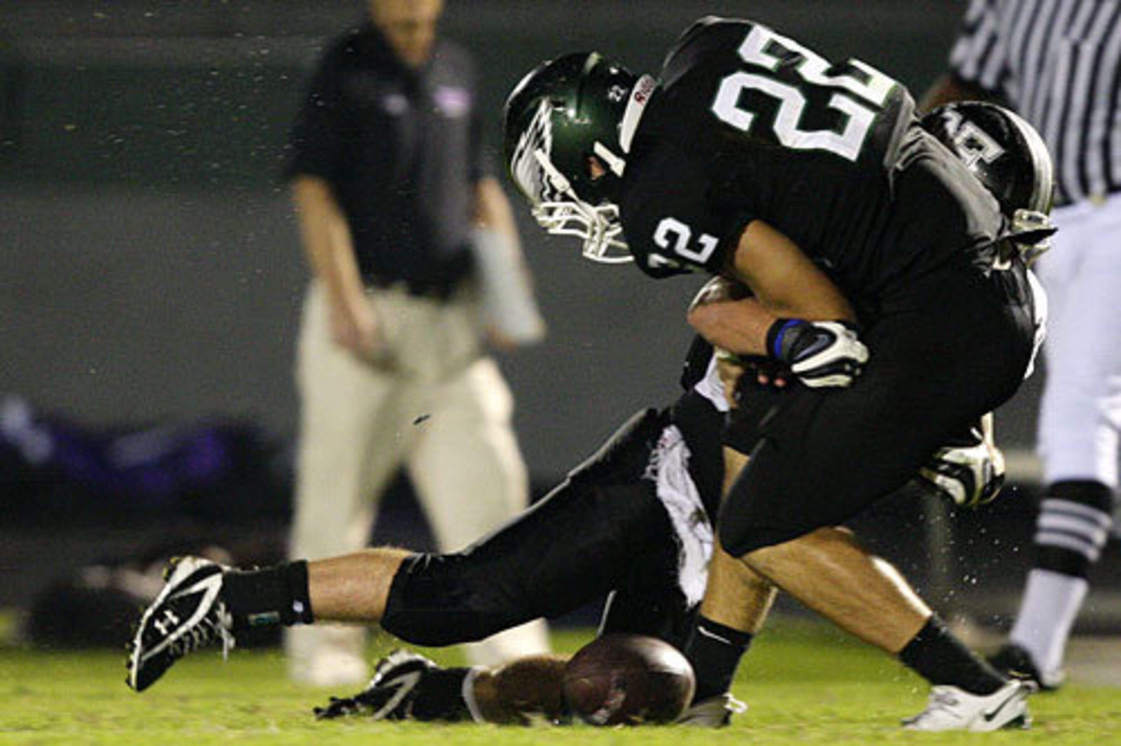 A North Forsyth defender causes Collins Hill's Timmy Quinones (22) to fumble a punt return during the second half.