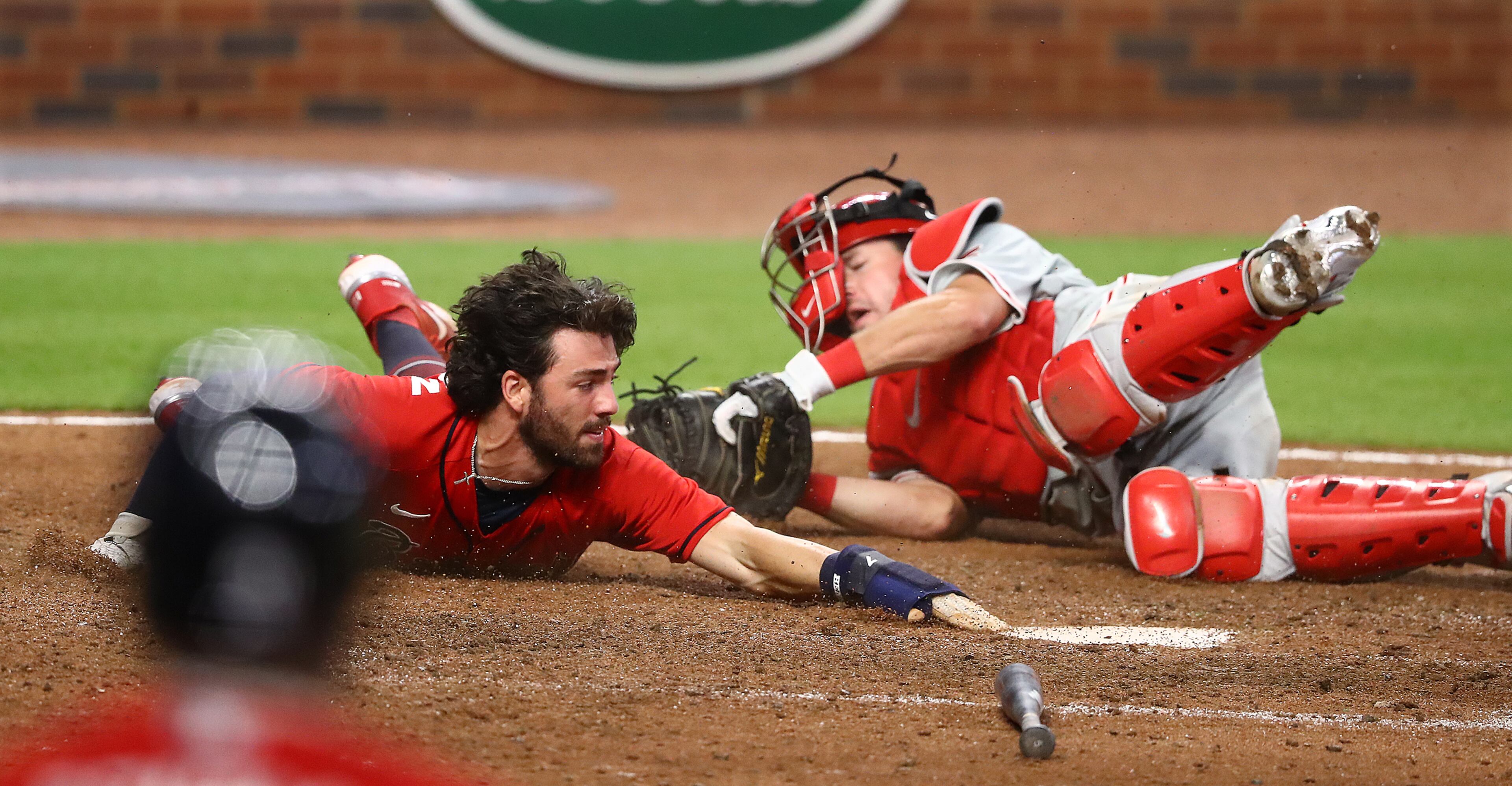 Atlanta Braves' Dansby Swanson dives home around Philadelphia Phillies catcher Andrew Knapp during the ninth inning in a MLB baseball game on Sunday, August 23, 2020 in Atlanta. Swanson was called out after a challenge on the tag stood to end the game 5-4. Curtis Compton ccompton@ajc.com