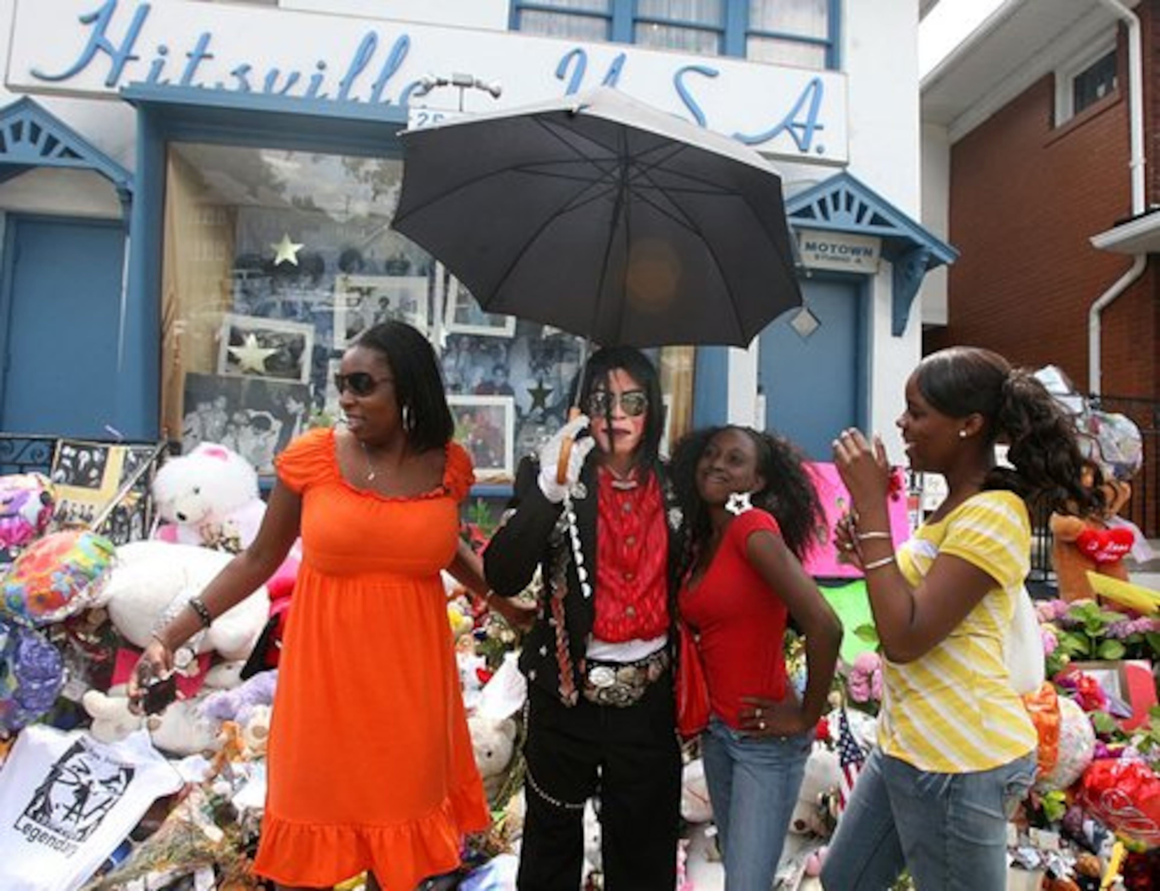 AFTER THE singer's death, fans (including Jackson impersonator Curtis Chapman, second left) gathered at the museum in Jackson's honor.