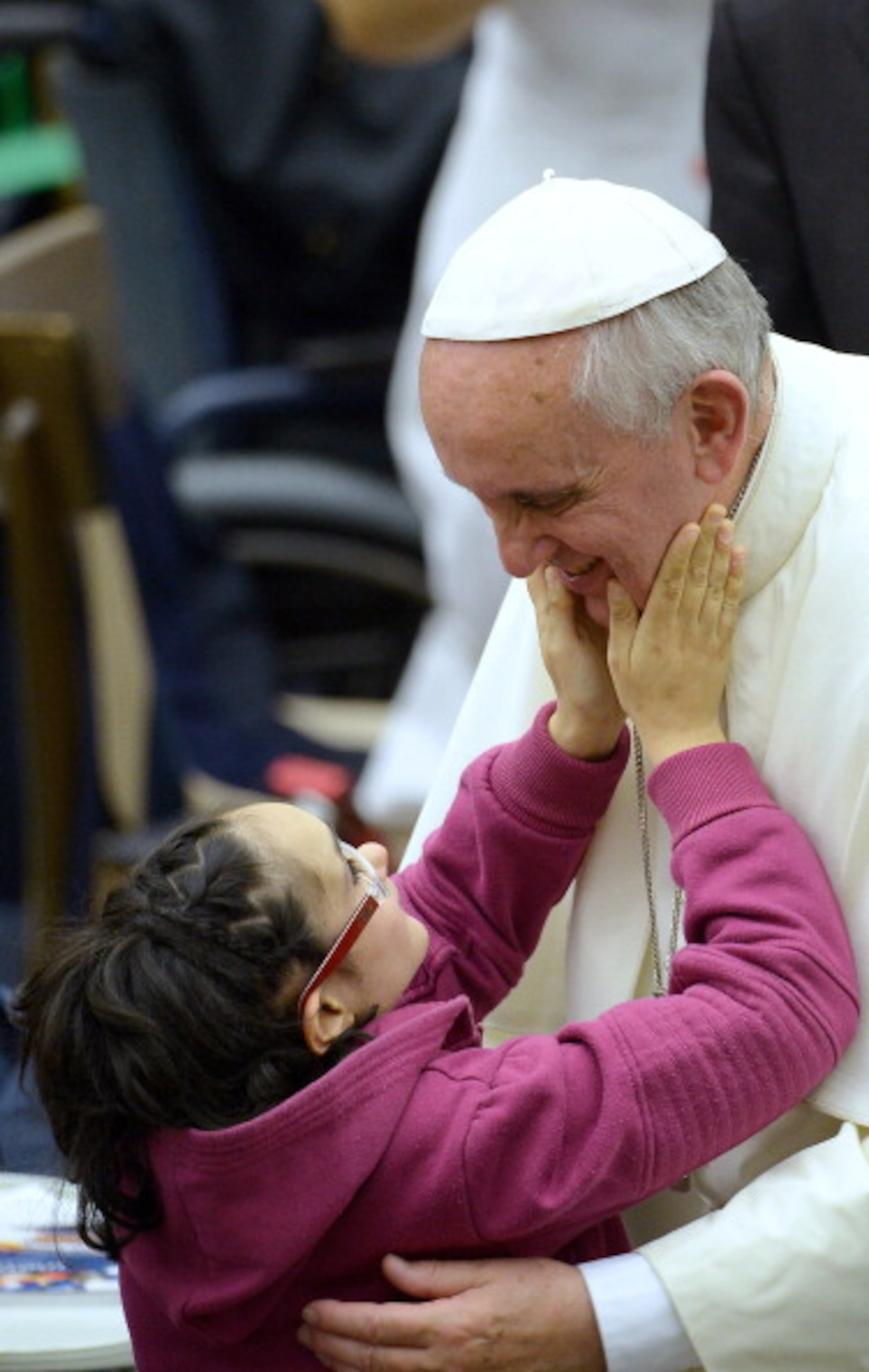 Pope Francis meets a disabled girl during a meeting with the UNITALSI, the Italian Union responsible for the transportation of sick people to Lourdes and the International Shrines in PaulVI hall, at the Vatican, on November 9, 2013. AFP PHOTO / FILIPPO MONTEFORTE (Photo credit should read FILIPPO MONTEFORTE/AFP/Getty Images)