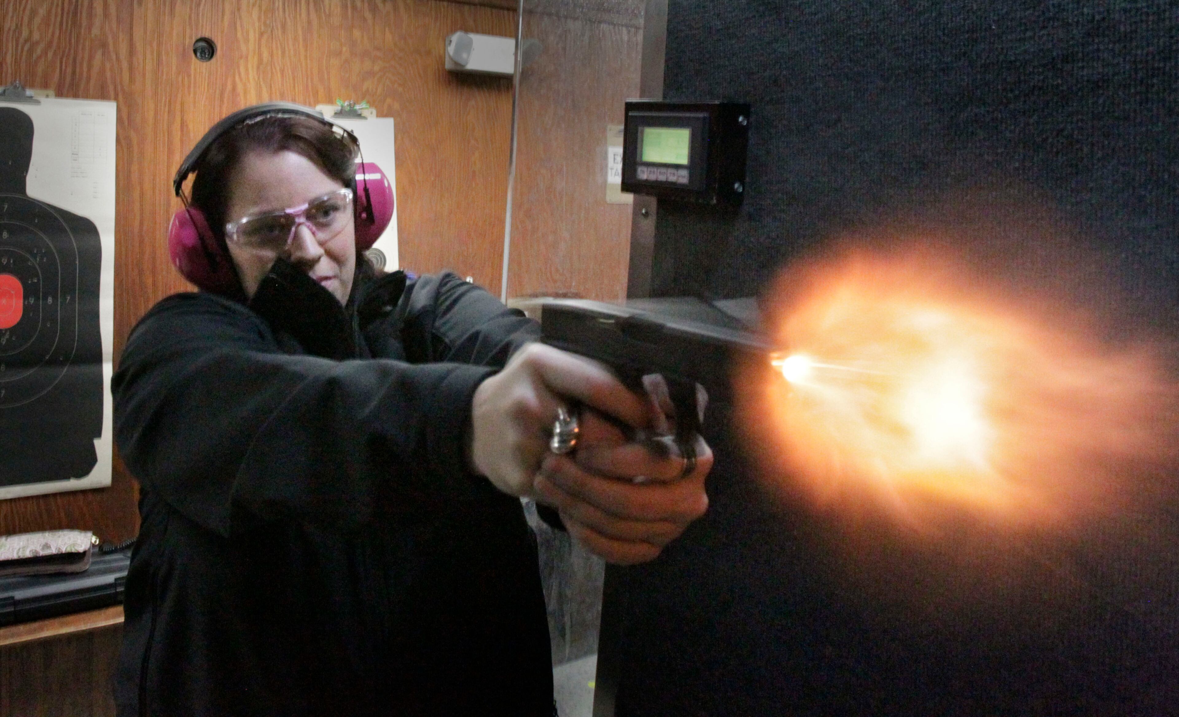Sydni Lee fires her Glock 19 at a gun range in Cumming in 2013. BOB ANDRES BANDRES@AJC.COM