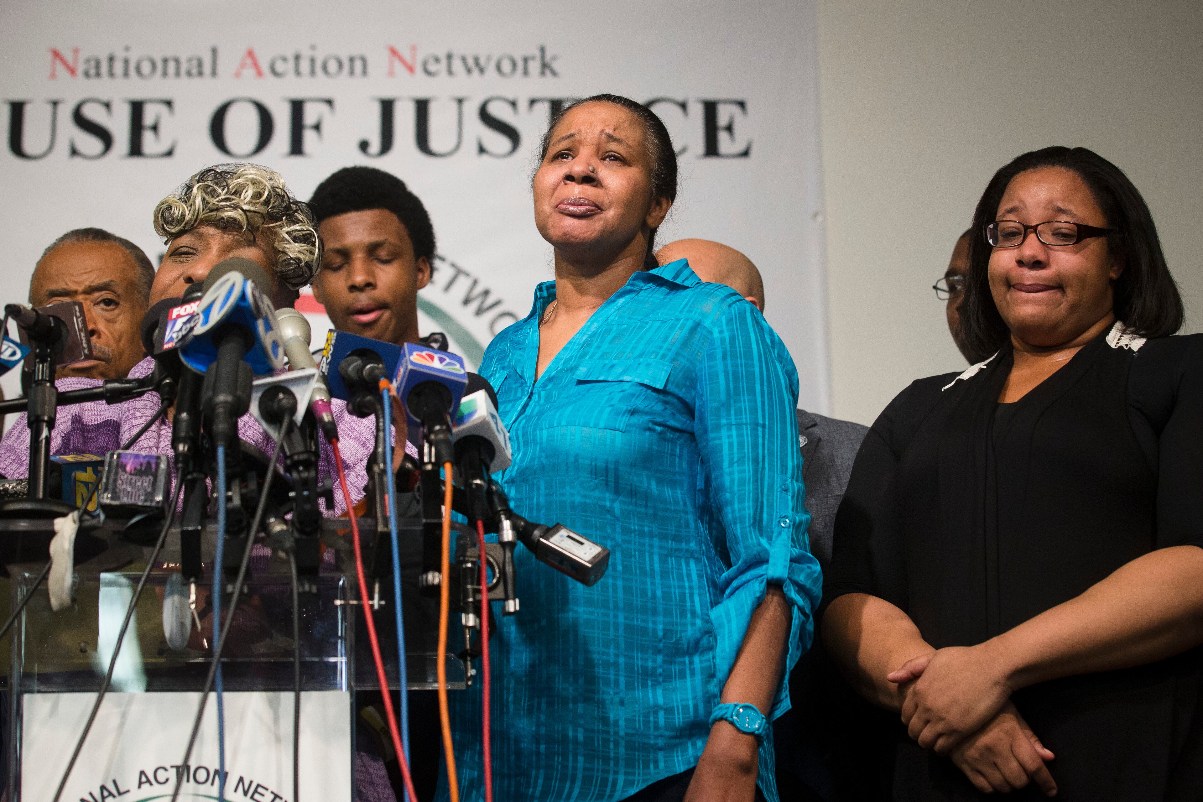 Esaw Garner, center, wife of Eric Garner, participates in a news conference at National Action Network headquarters in New York on Wednesday, Dec. 3, 2014 after a grand jury's decision not to indict a New York police officer involved in her husband's death. A video shot by an onlooker and widely viewed on the Internet showed the 43-year-old Garner telling a group of police officers to leave him alone as they tried to arrest him. The city medical examiner ruled Garner's death a homicide and found that a chokehold contributed to it. (AP Photo/John Minchillo)