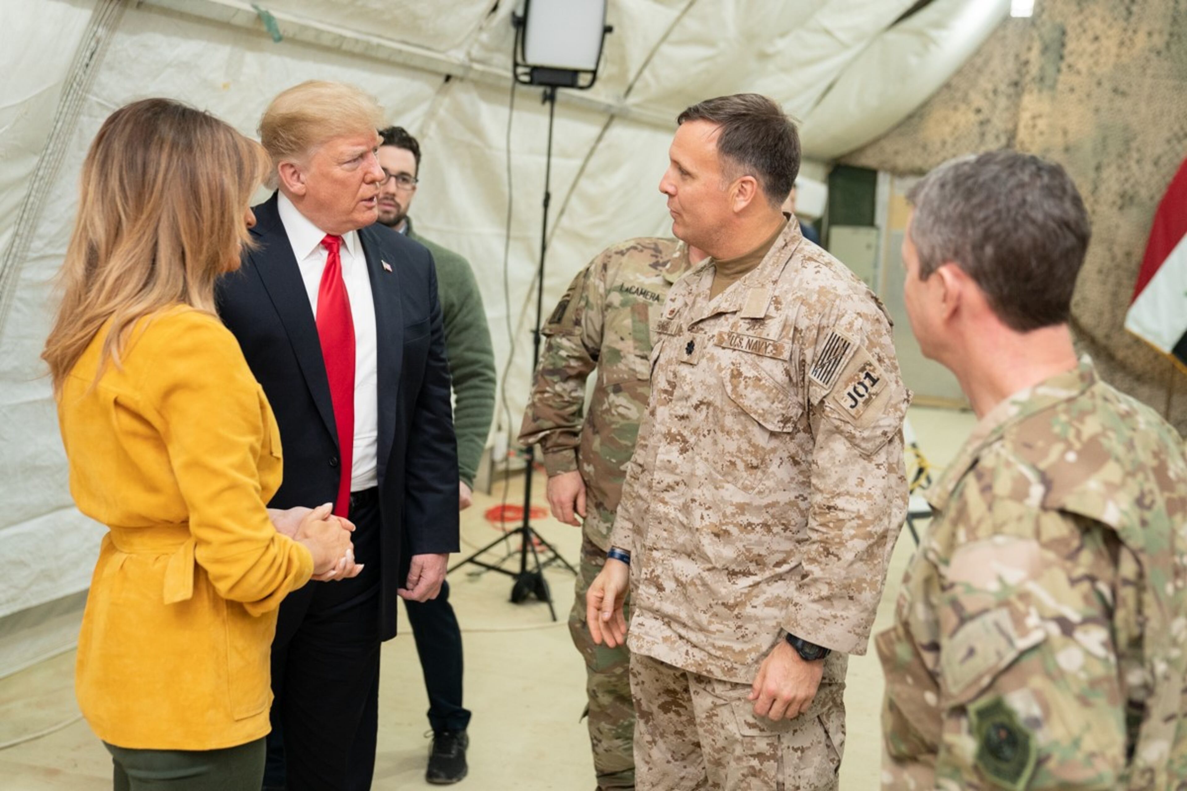 President Donald J. Trump, joined by First Lady Melania Trump, speaks with military leadership members Wednesday, December 26, 2018, following a briefing at the Al-Asad Airbase in Iraq.
