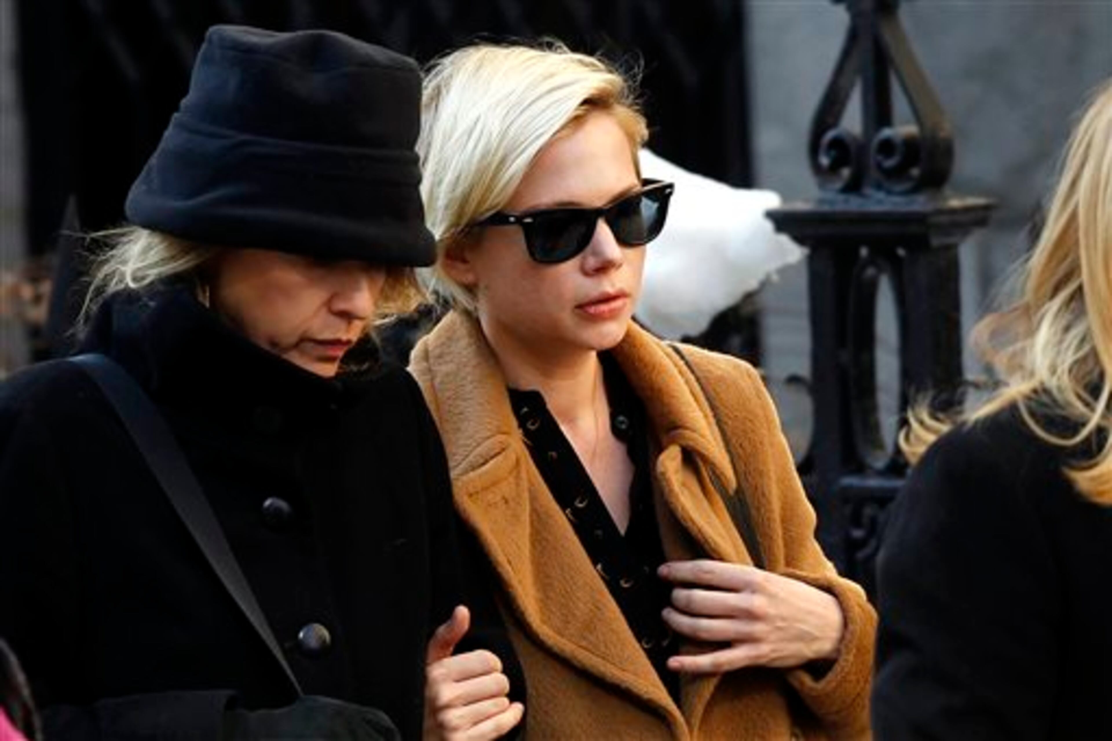 Actress Michelle Williams, right, arrives at the Church of St. Ignatius Loyola for the private funeral of actor Philip Seymour Hoffman Friday, Feb. 7, 2014, in New York. Hoffman, 46, was found dead Sunday of an apparent heroin overdose. (AP Photo/Jason DeCrow)