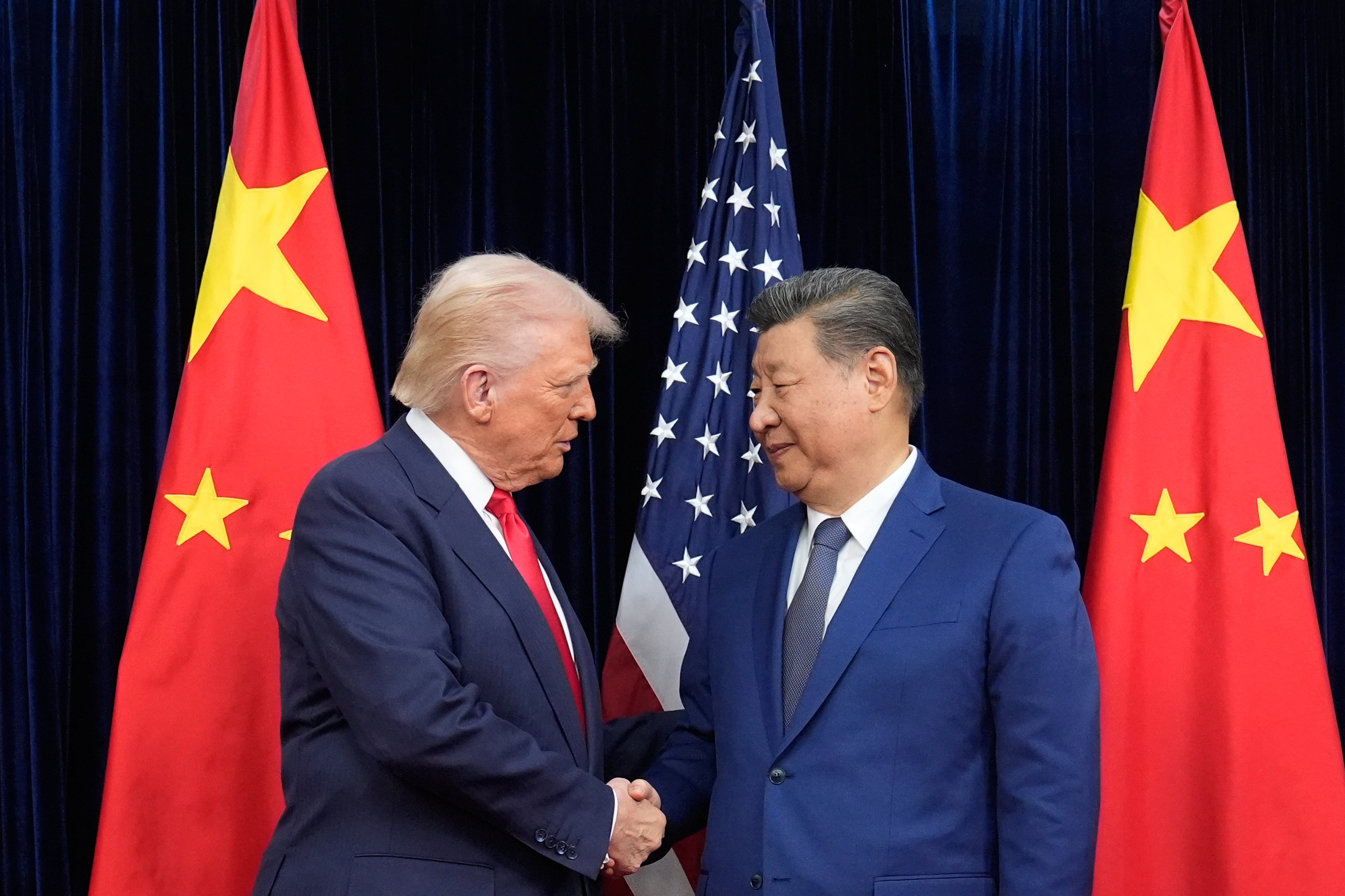 President Donald Trump, left, and Chinese President Xi Jinping, right, shake hands before their meeting at Gimhae International Airport in Busan, South Korea, Thursday, Oct. 30, 2025. (Mark Schiefelbein/AP)