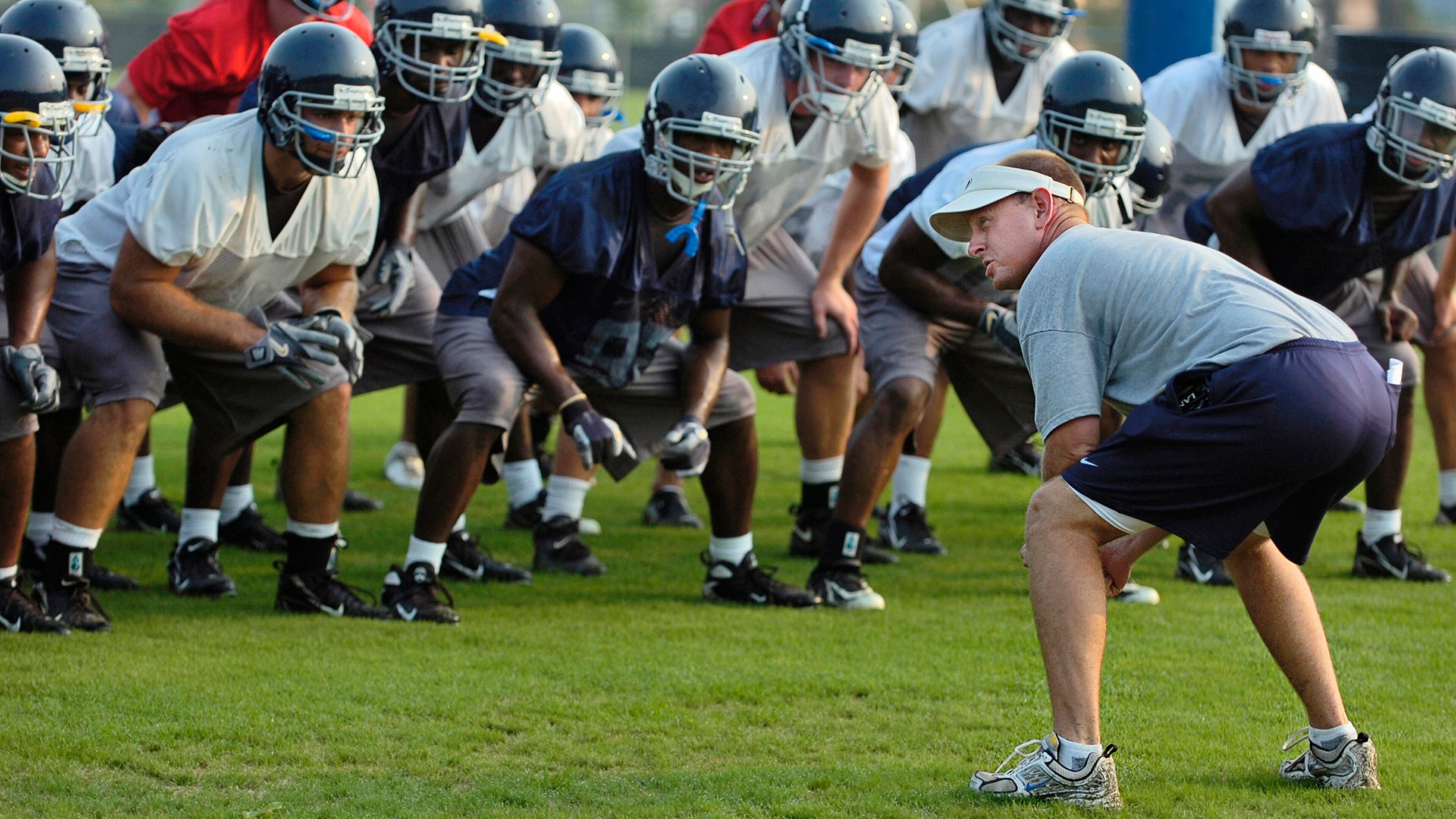 Chris Hatcher, right, leads his Georgia Southern team in the "Beautiful Eagle Creek Salute" during a preseason practice in 2007, shortly after he had been hired as head coach. (AP Photo/the Statesboro Herald, Scott Bryant)