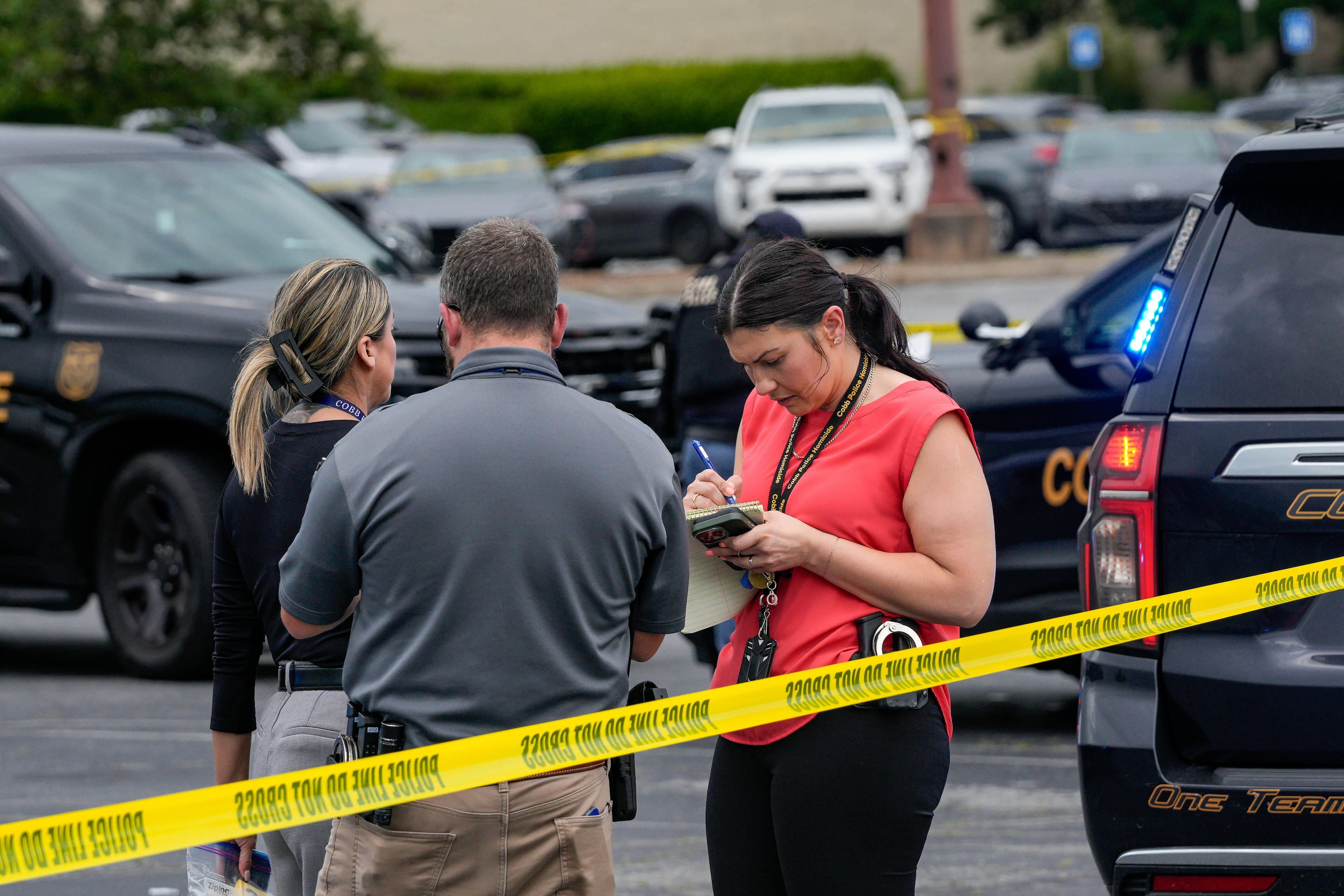 Officials respond to an officer-involved shooting investigation in the parking lot of the Town Center at Cobb mall on Wednesday, May 27, 2026. (Ben Hendren for the AJC)